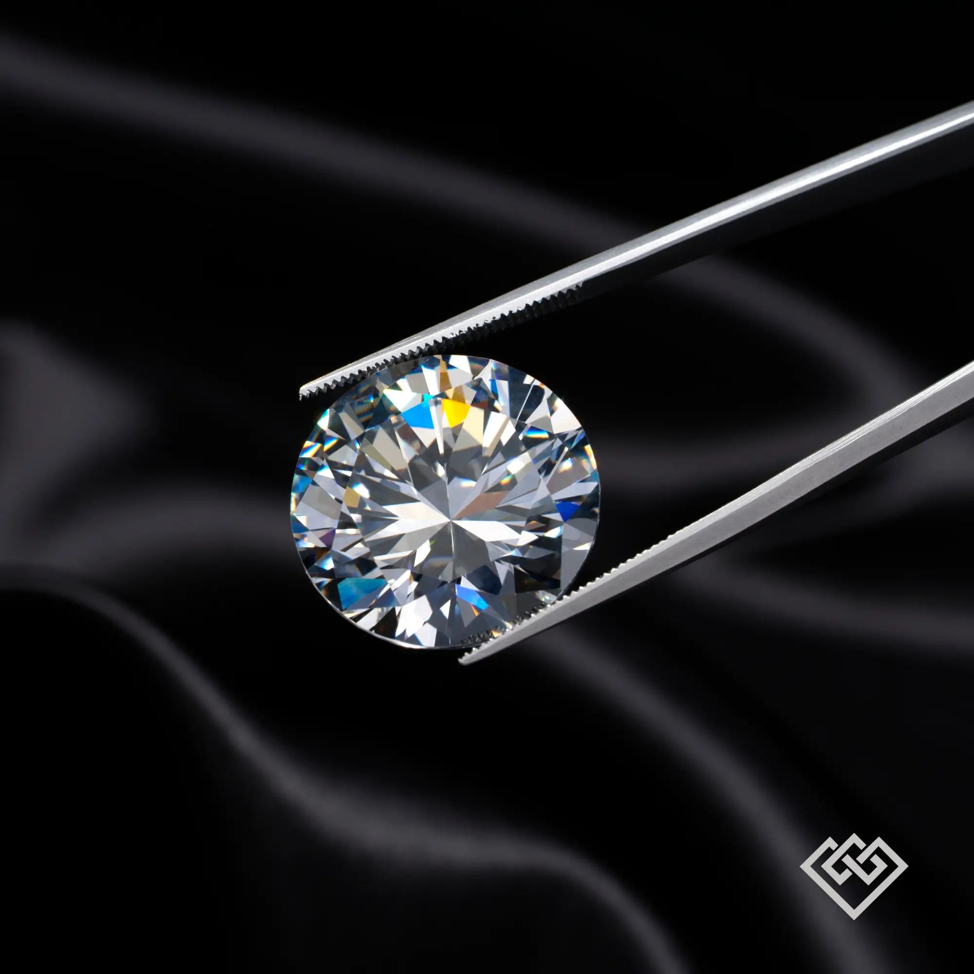 Round brilliant cut diamond held by tweezers on black silk background, gemstone close-up