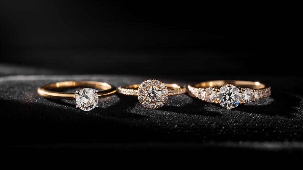 Different types of engagement rings including solitaire, halo, and three-stone settings