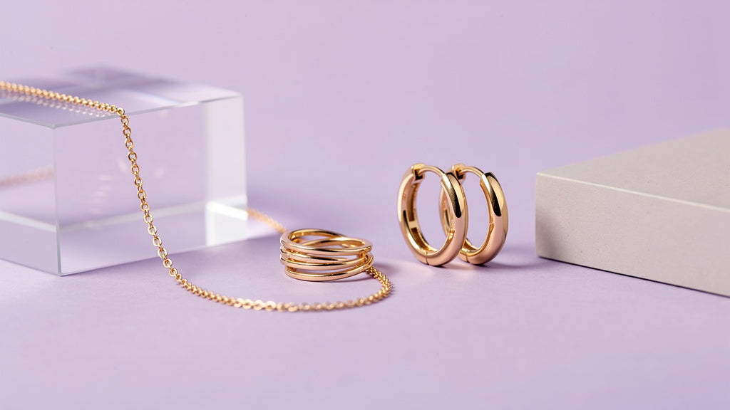 Affordable fashion jewelry collection with a gold chain, stacked rings, and hoop earrings
