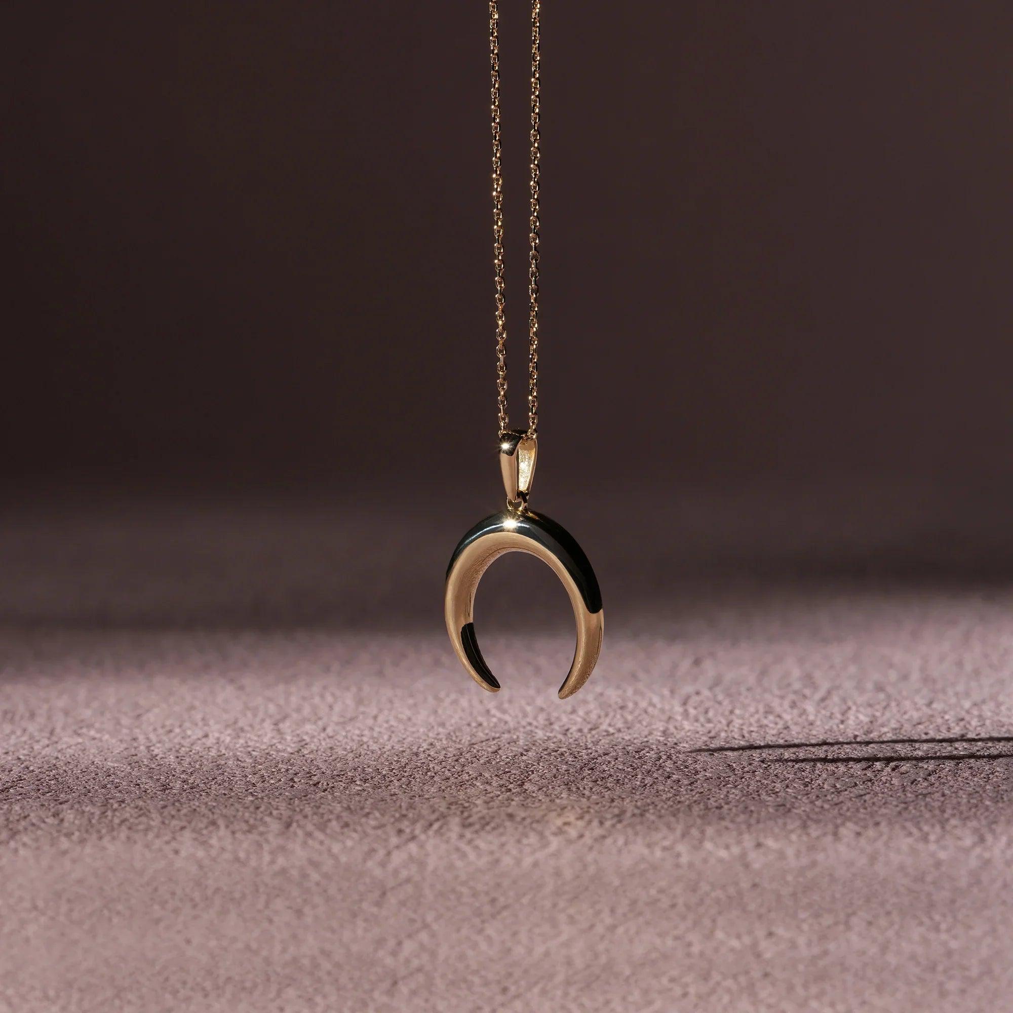 Gold crescent moon pendant necklace on delicate chain, minimalist jewelry photo