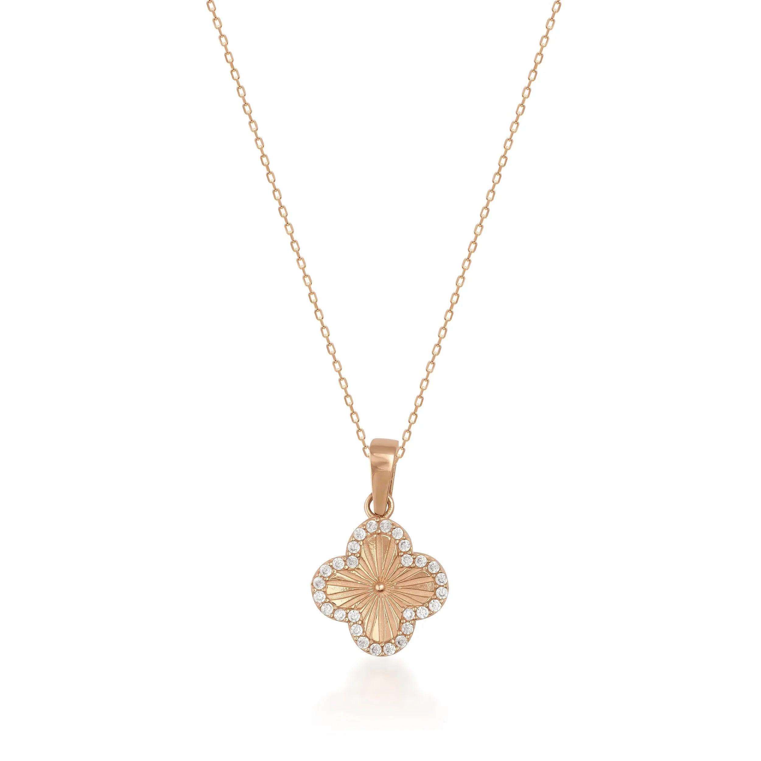Gold clover pendant necklace with diamond accents on a fine gold chain, elegant jewelry