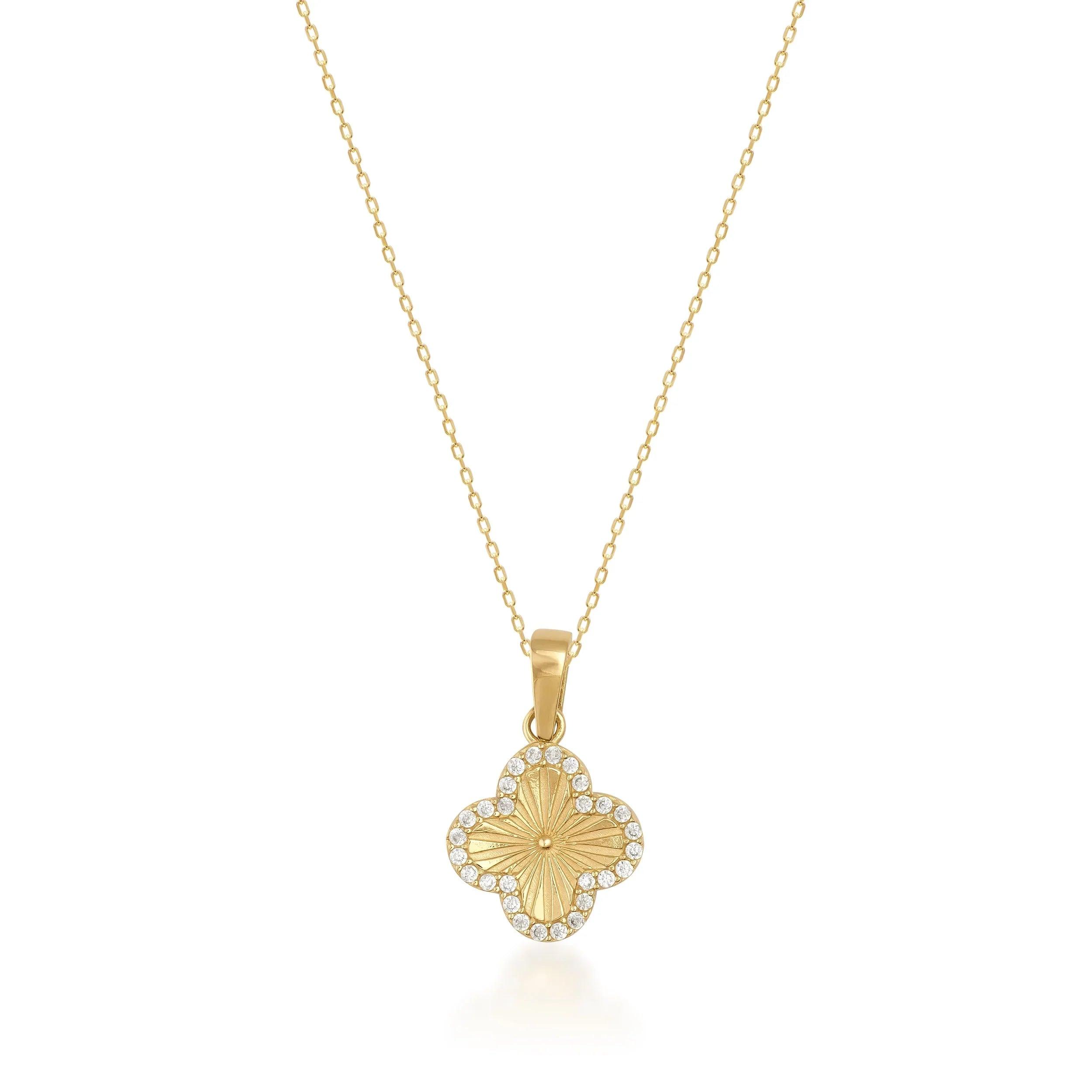 Gold clover-shaped pendant necklace with diamond accents on a delicate gold chain