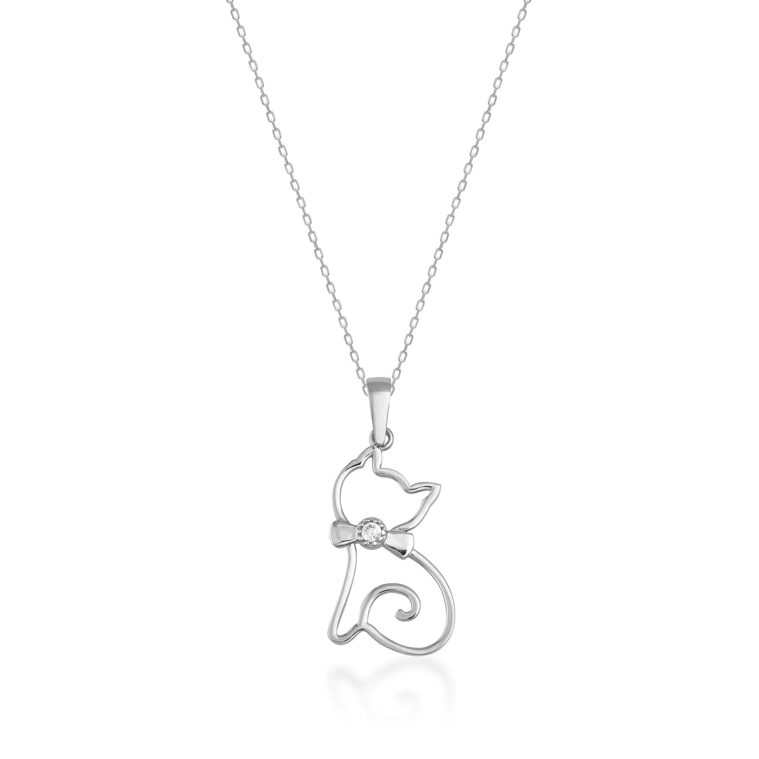 Gold cat pendant necklace with bow and gemstone on fine chain, minimalist jewelry design