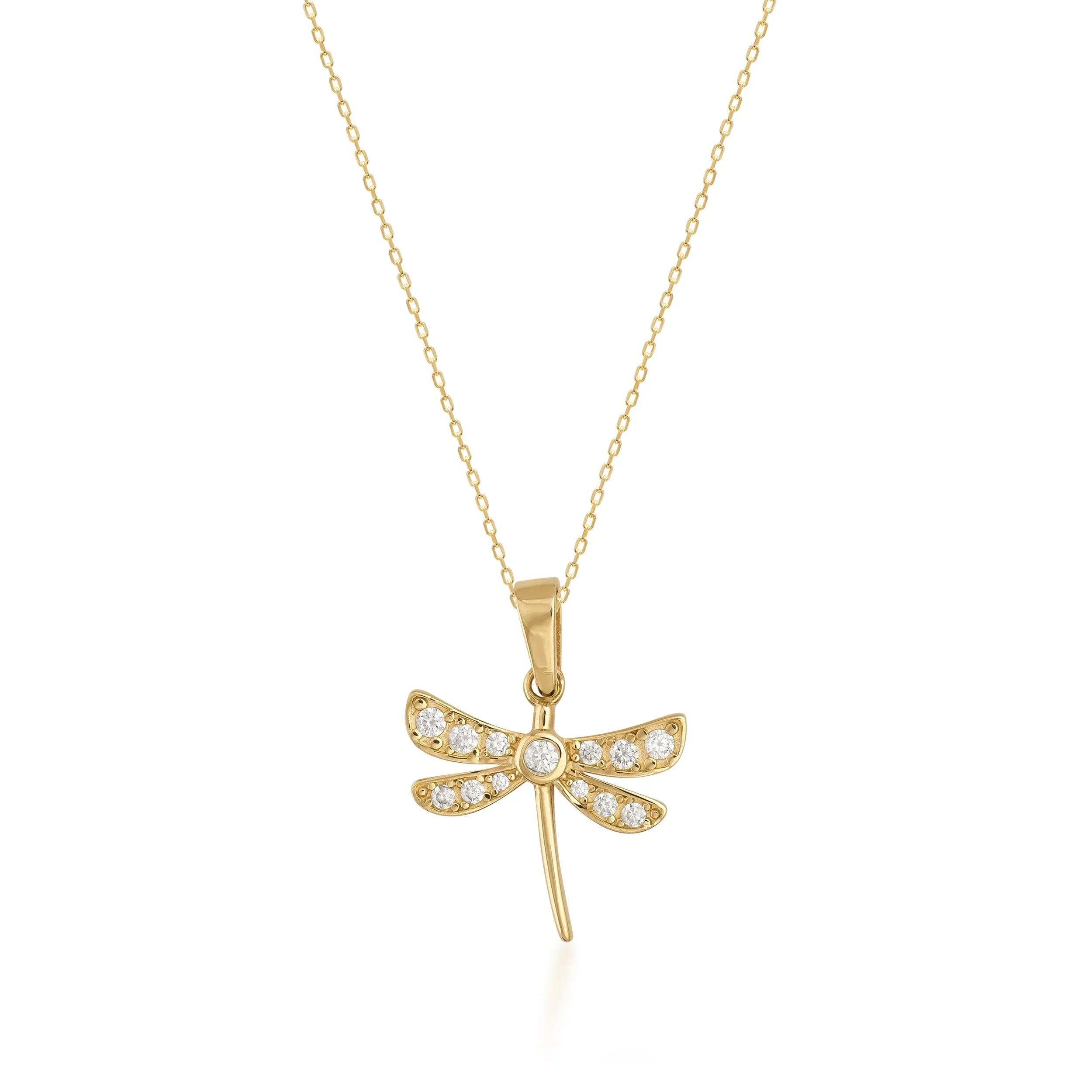 Gold dragonfly pendant necklace with cubic zirconia accents on a fine gold chain, isolated on white