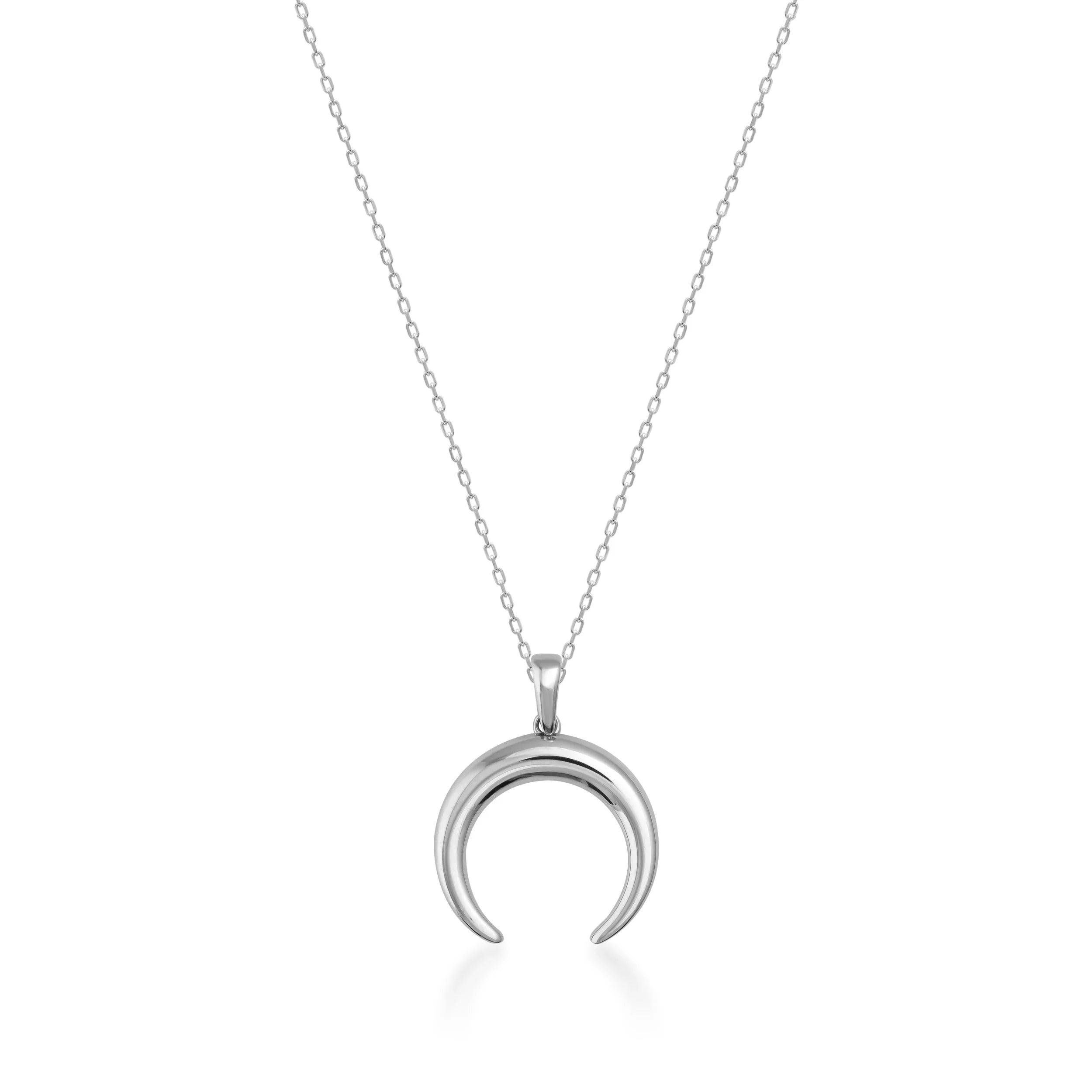 Silver crescent moon pendant necklace with delicate chain on white background