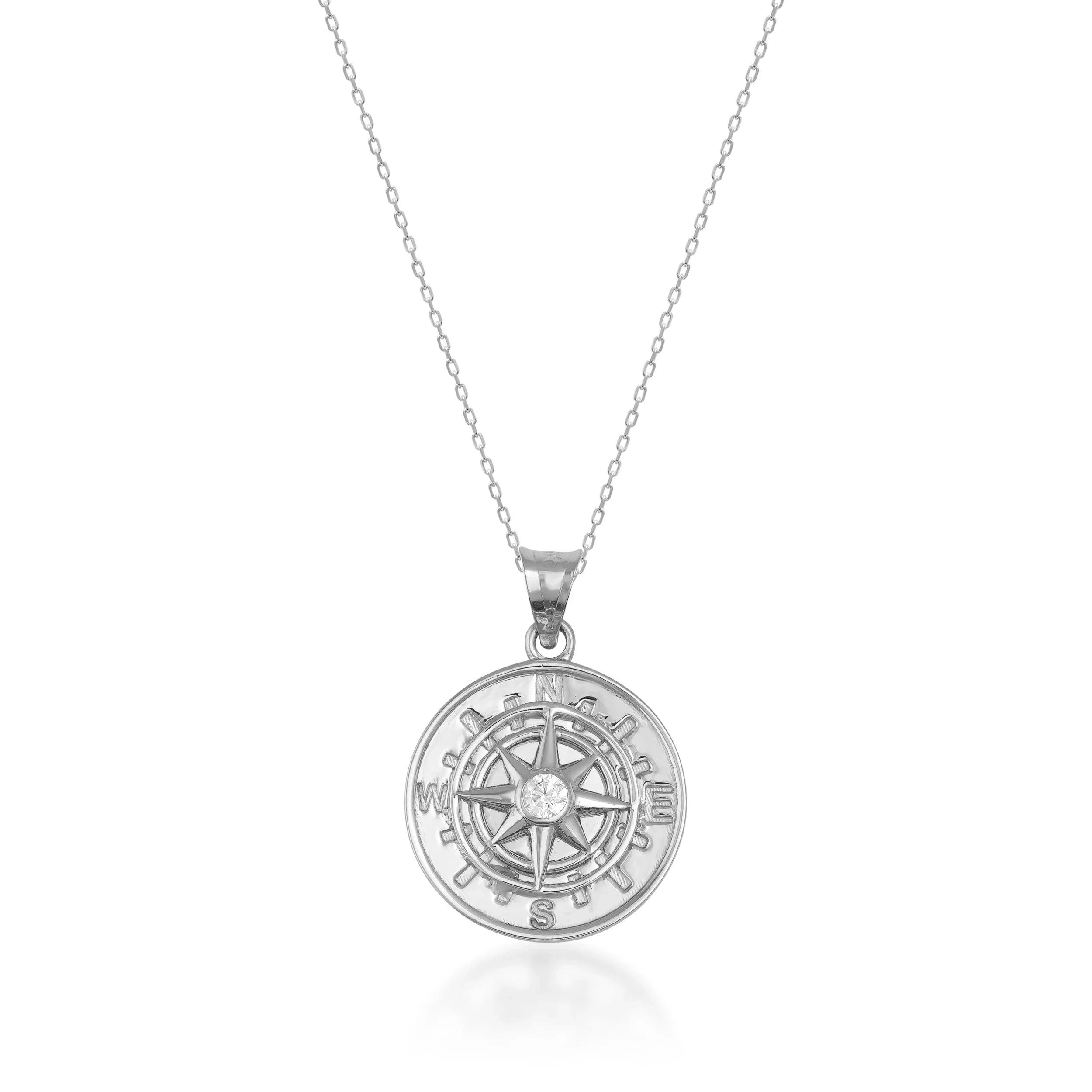 Gold compass pendant necklace with gemstone center on fine chain, elegant jewelry