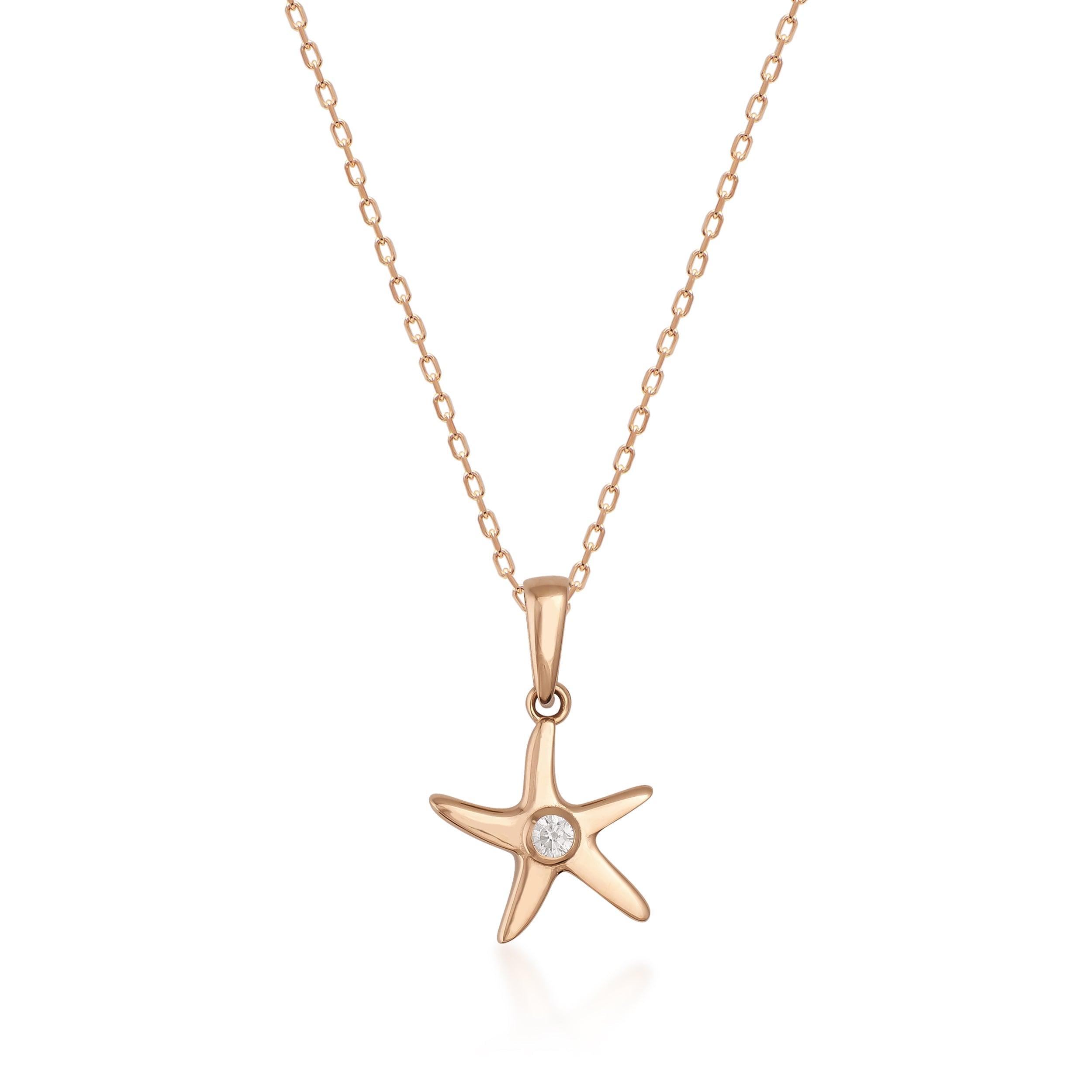 Gold starfish pendant necklace with central gemstone on delicate gold chain