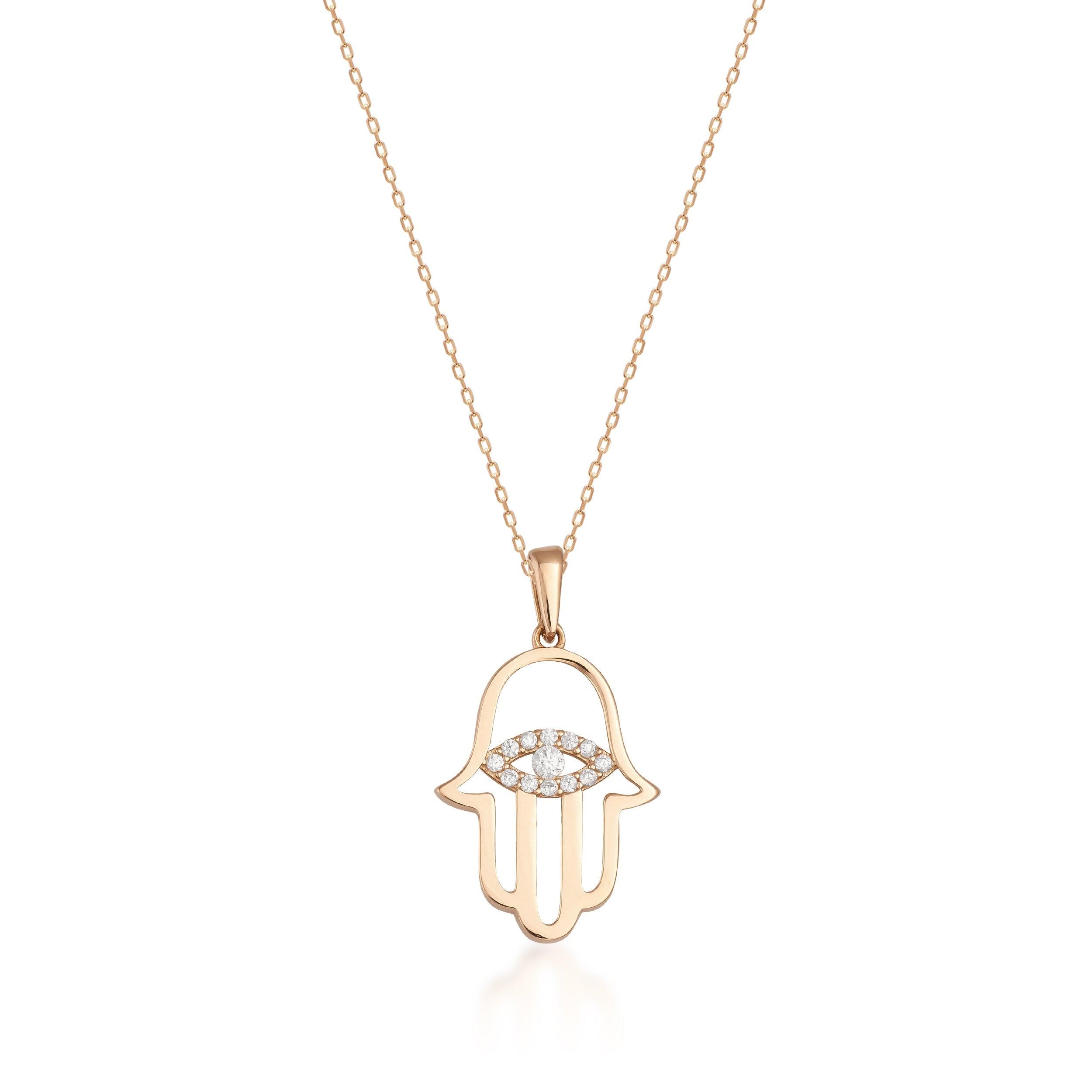 Gold Hamsa hand necklace with diamond eye pendant on fine chain, white background