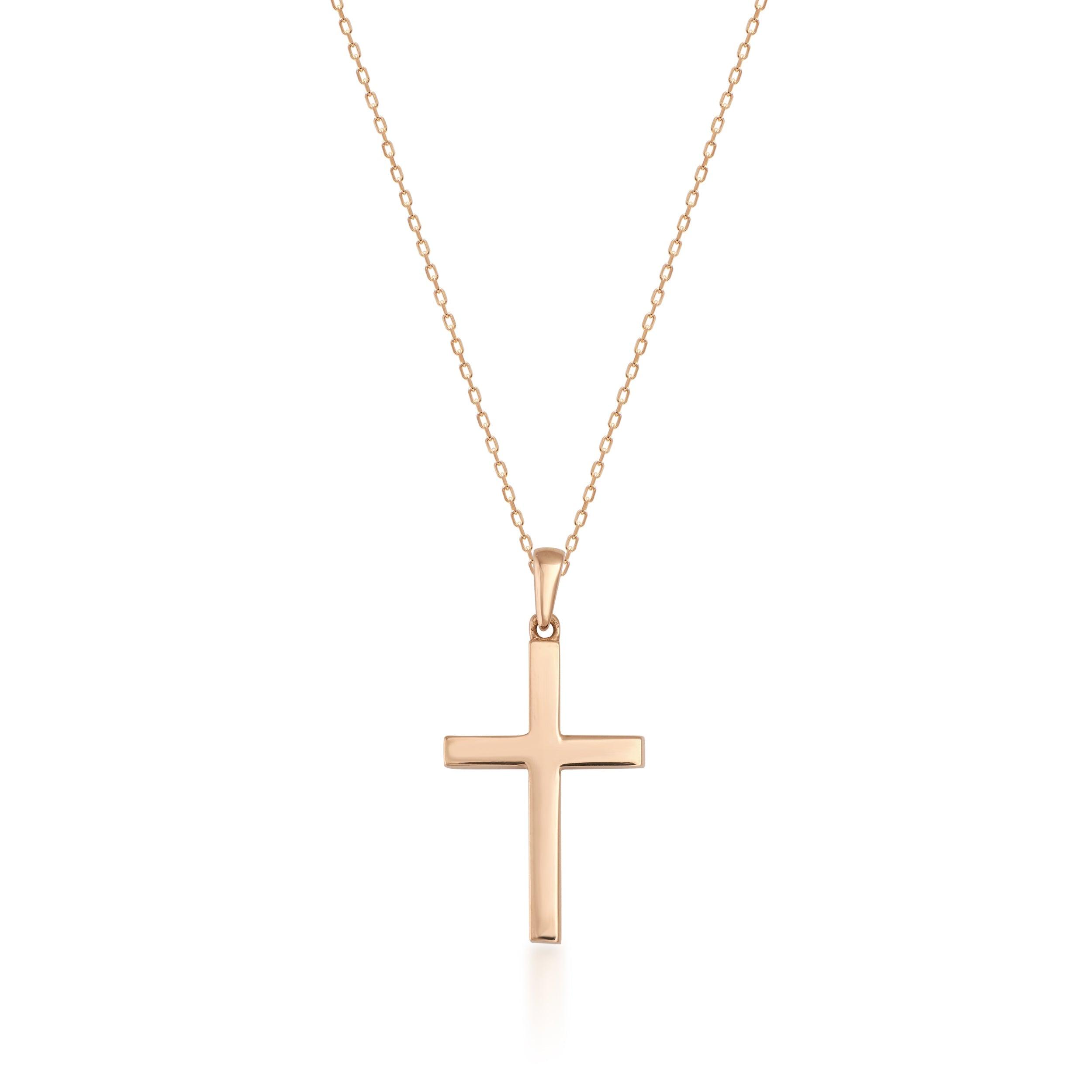 Gold cross pendant necklace on a delicate chain, simple elegant jewelry on white background
