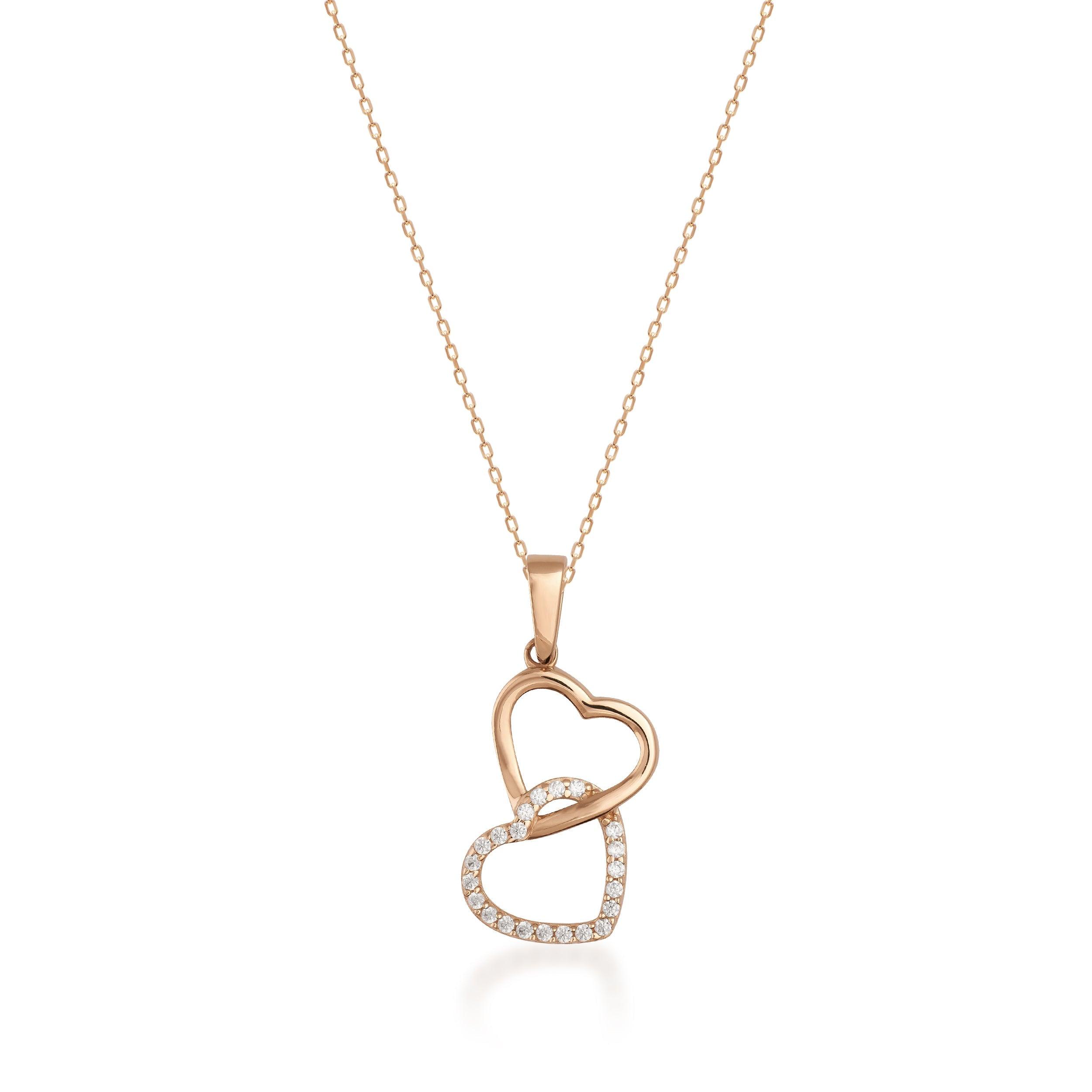 Gold necklace with two interlocking heart pendants, one accented with diamonds
