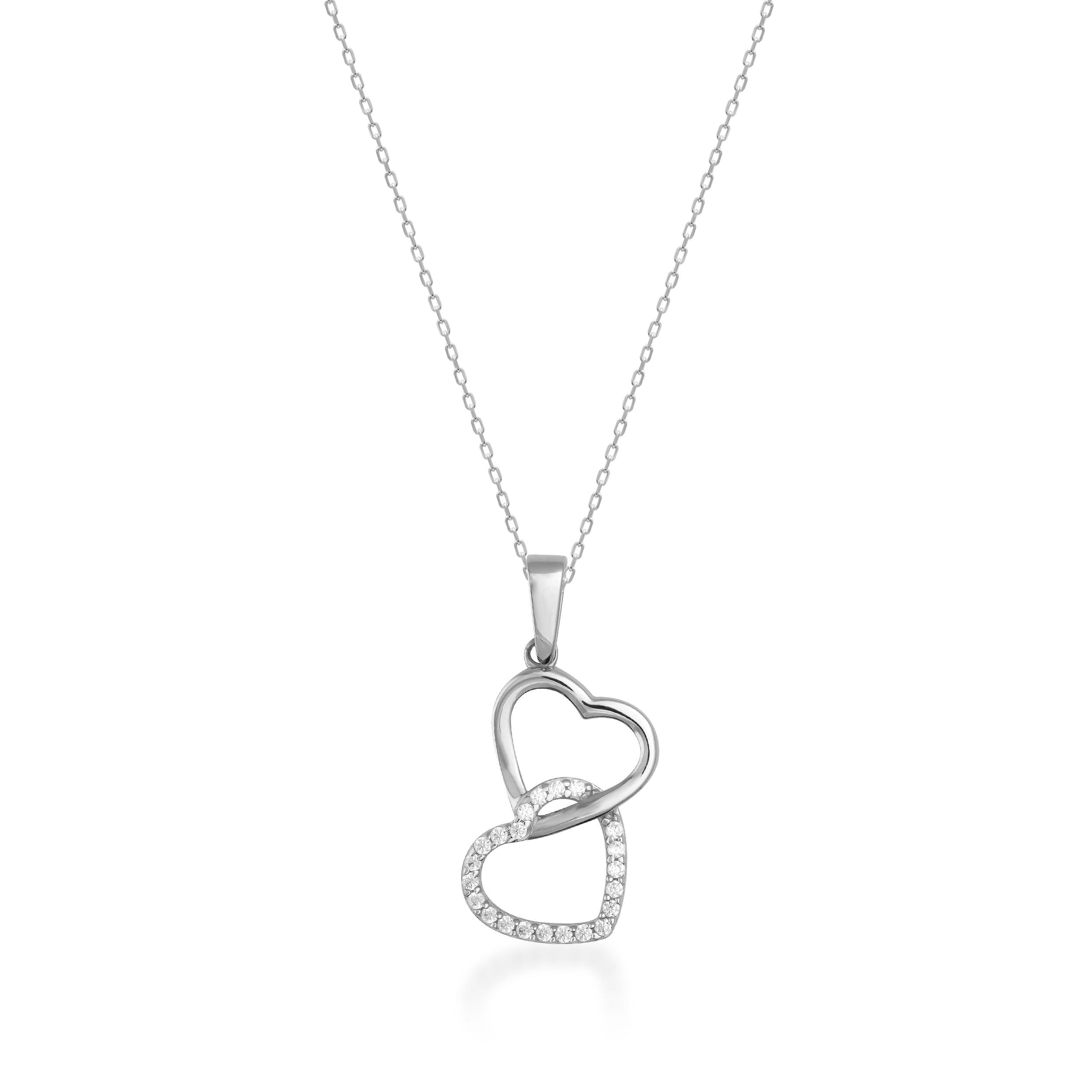 Gold necklace with two interlocking heart pendants, one accented with sparkling stones