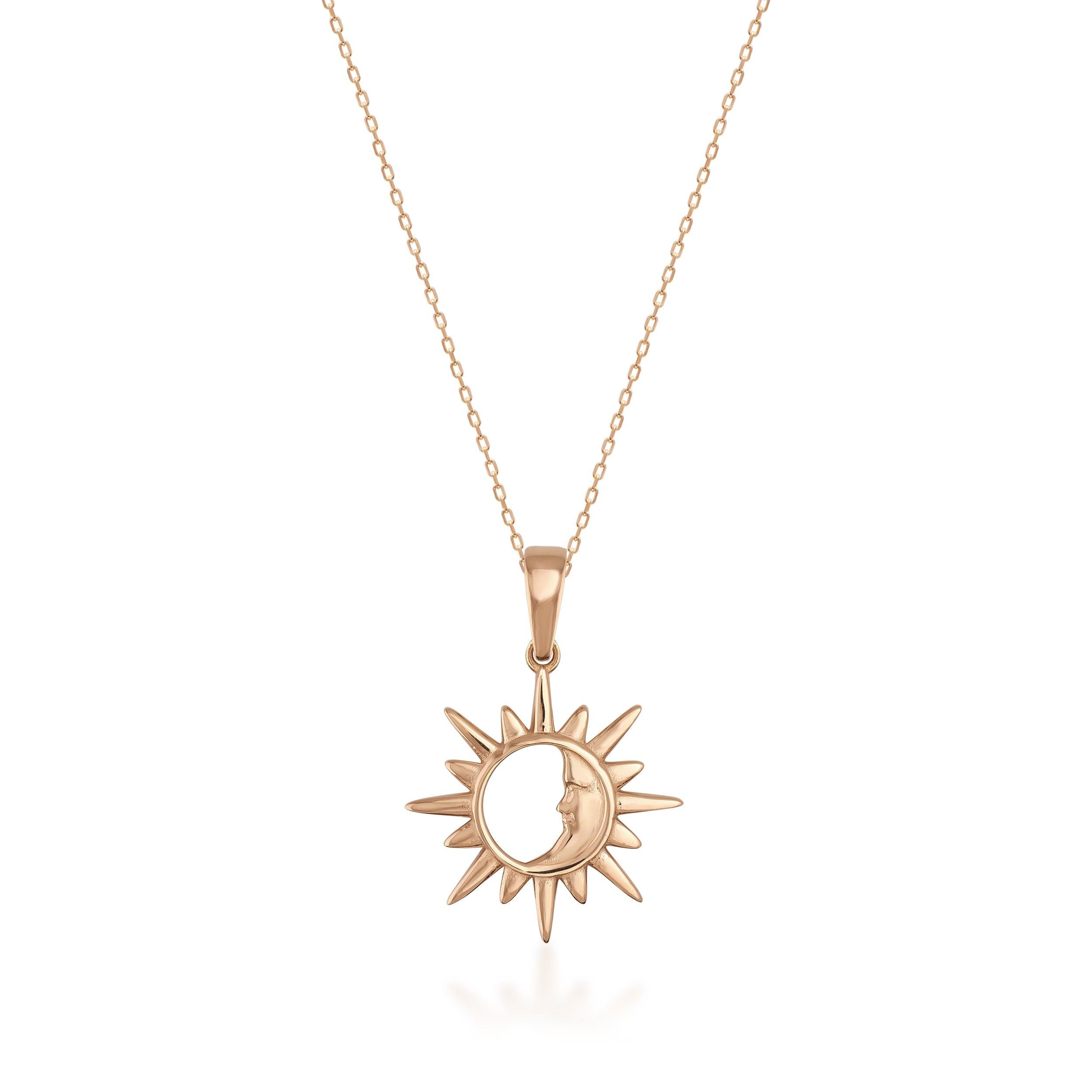 Gold sun and moon pendant necklace with fine chain on white background