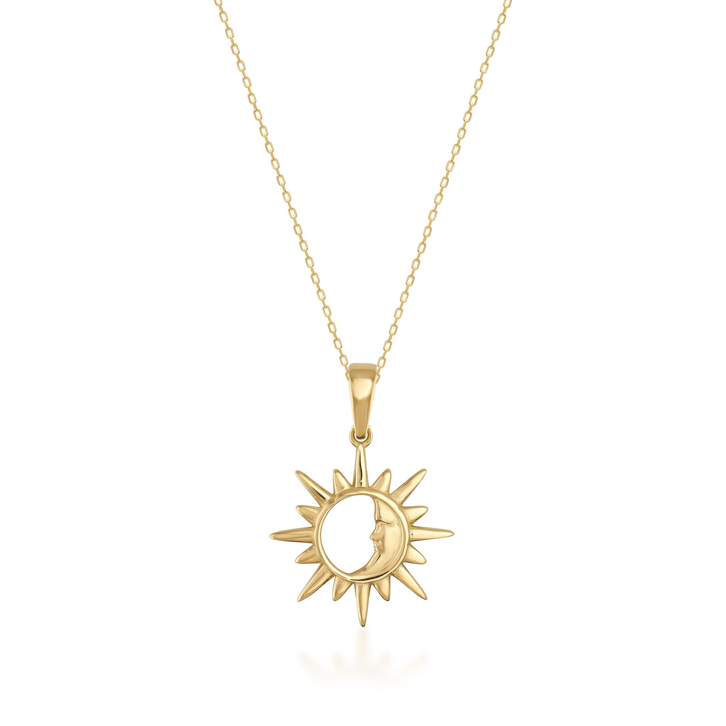 Gold sun and moon pendant necklace with fine chain on white background