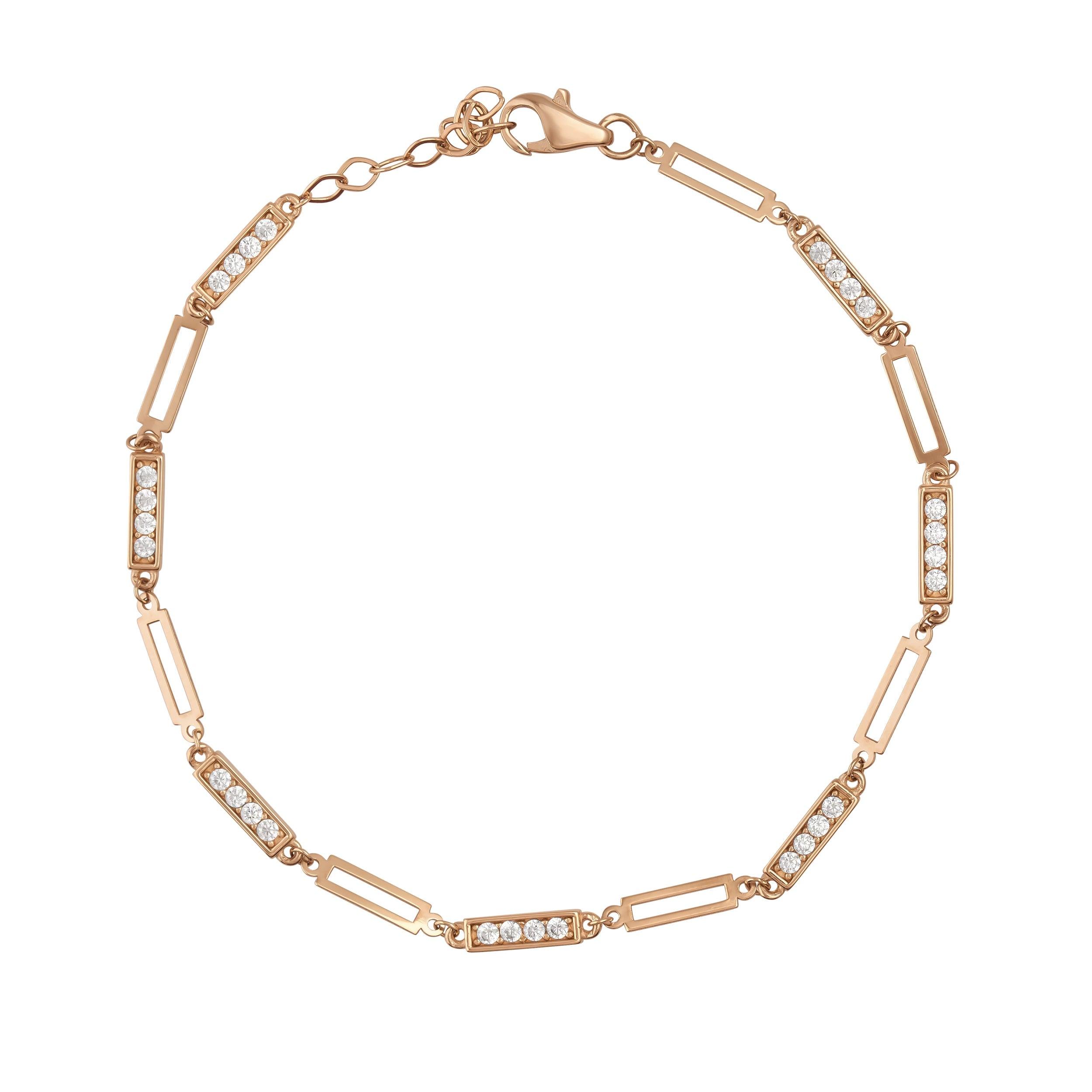 Delicate gold bracelet with rectangular links and inset sparkling gemstones on white background