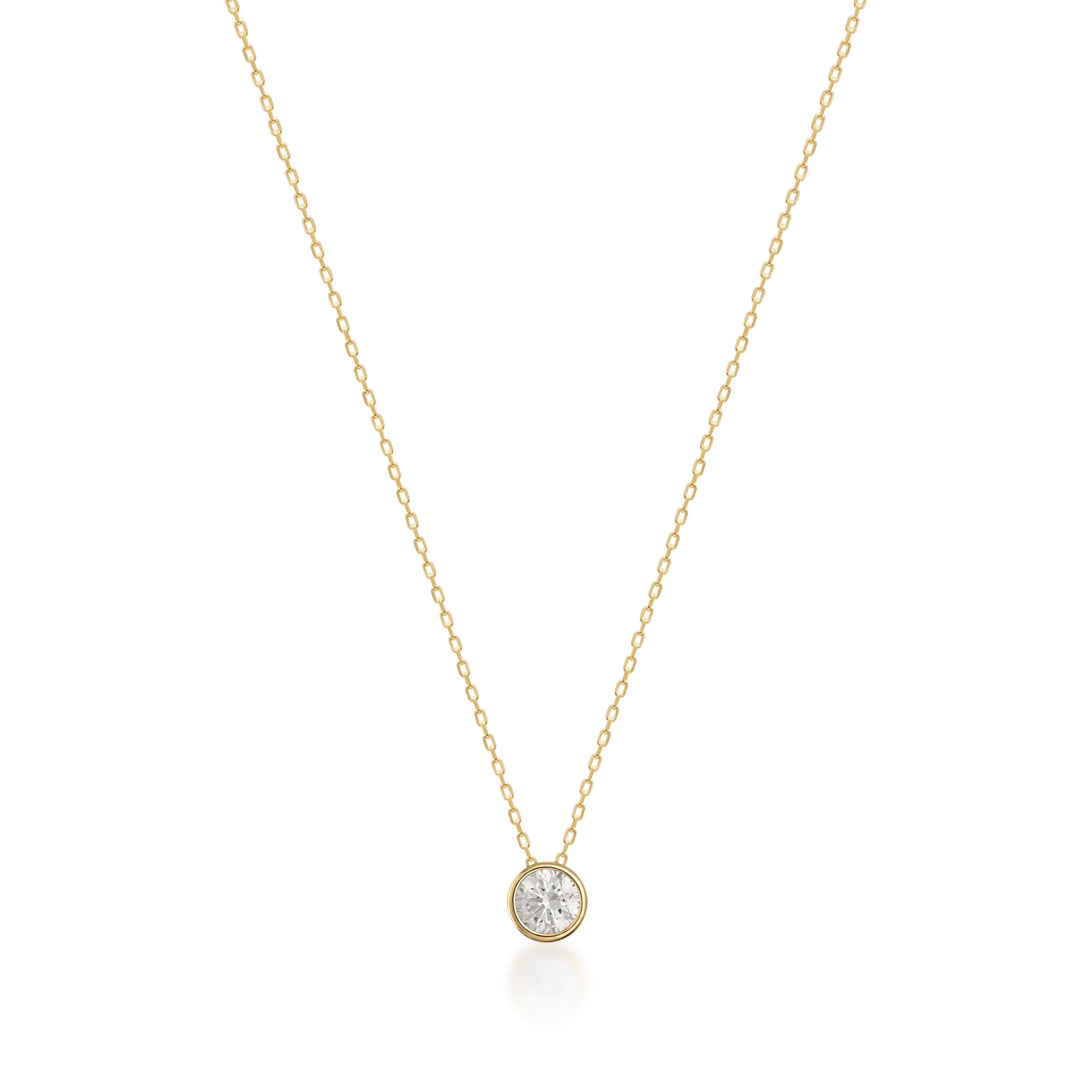 Gold chain necklace with solitaire round diamond pendant on white background