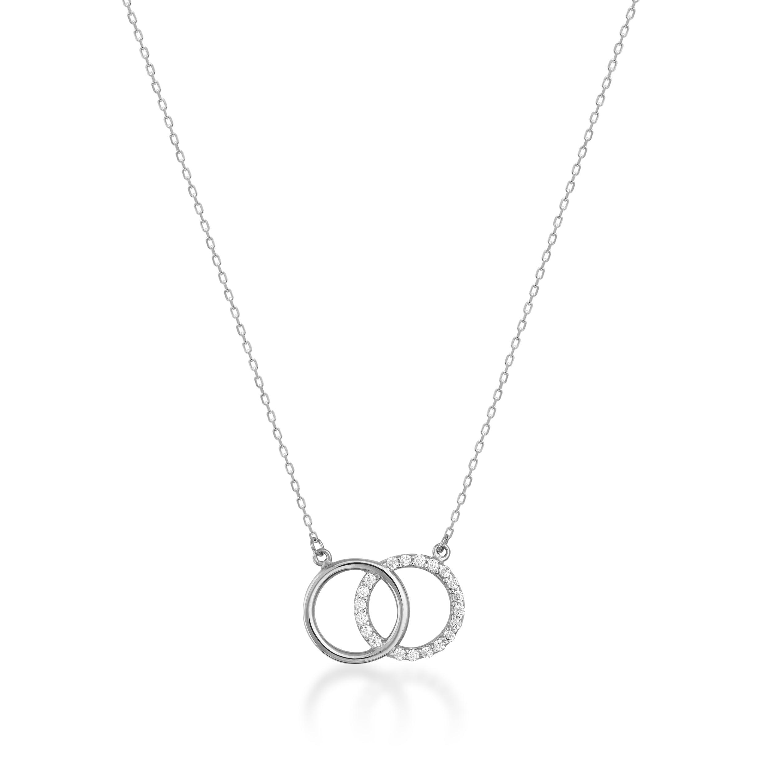 Delicate gold necklace with interlocking circle pendants, one set with sparkling stones