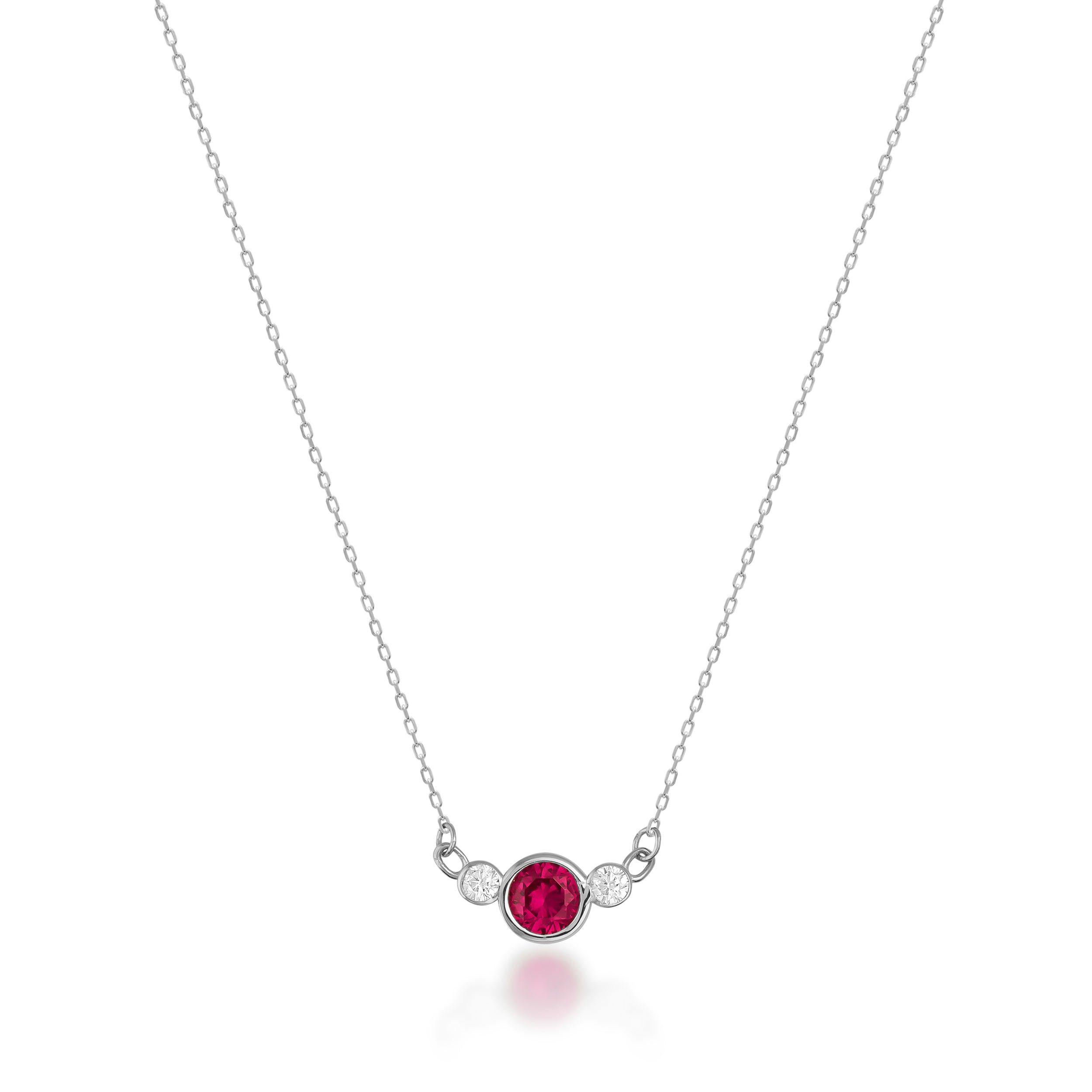 White gold necklace with central round red gemstone and two sparkling side diamonds