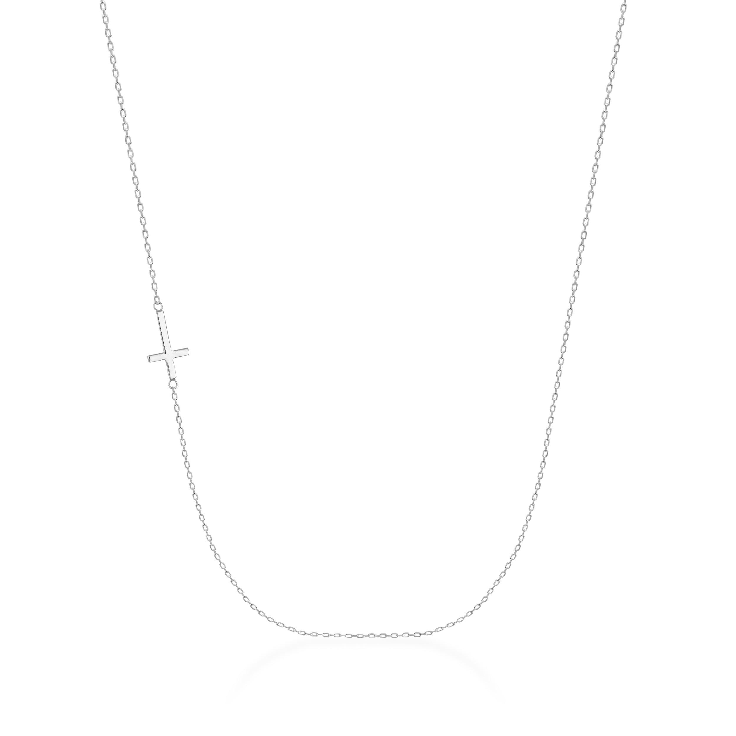 Delicate gold chain necklace with a sideways cross pendant on a white background