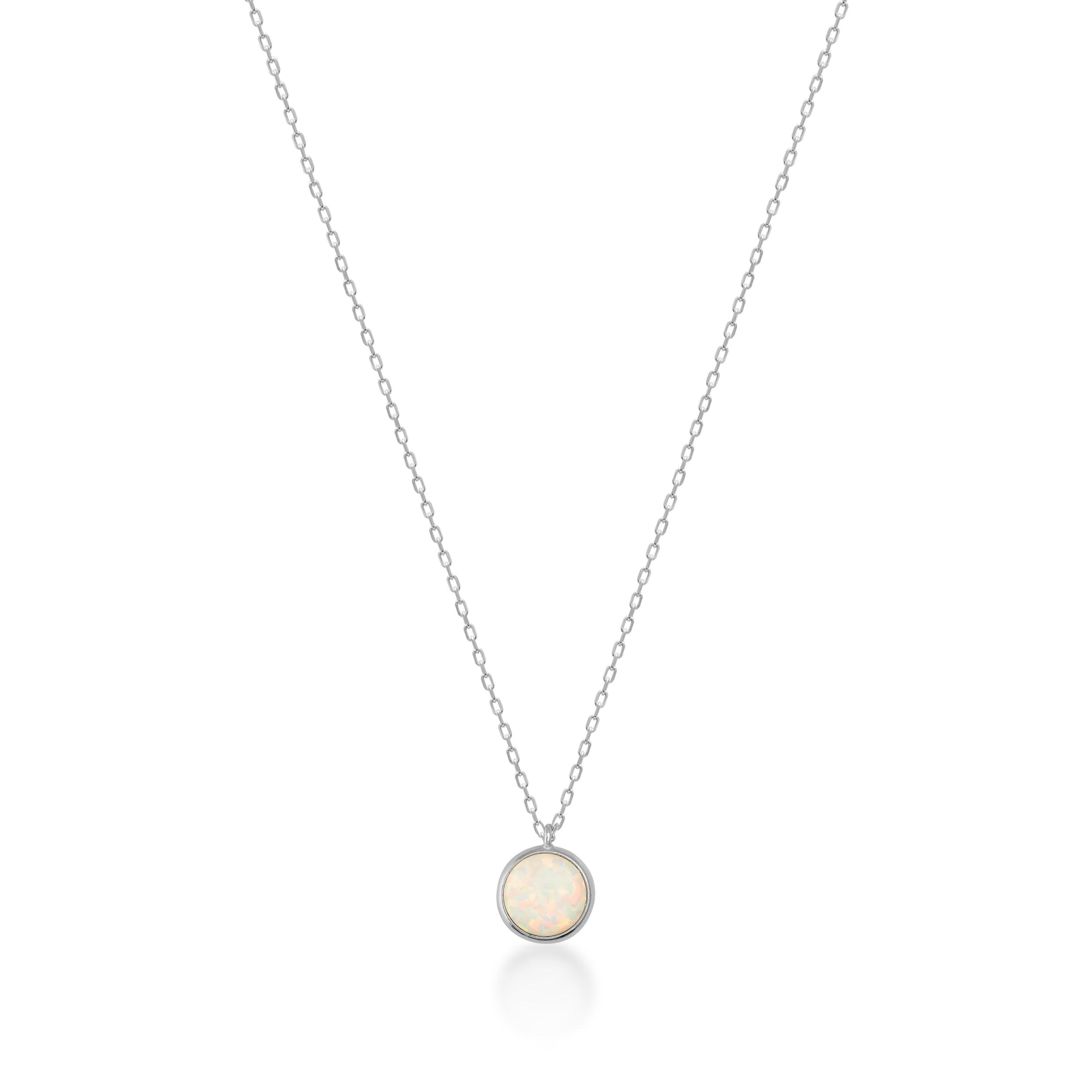 Opal pendant necklace with a round white opal stone on a delicate gold chain, isolated