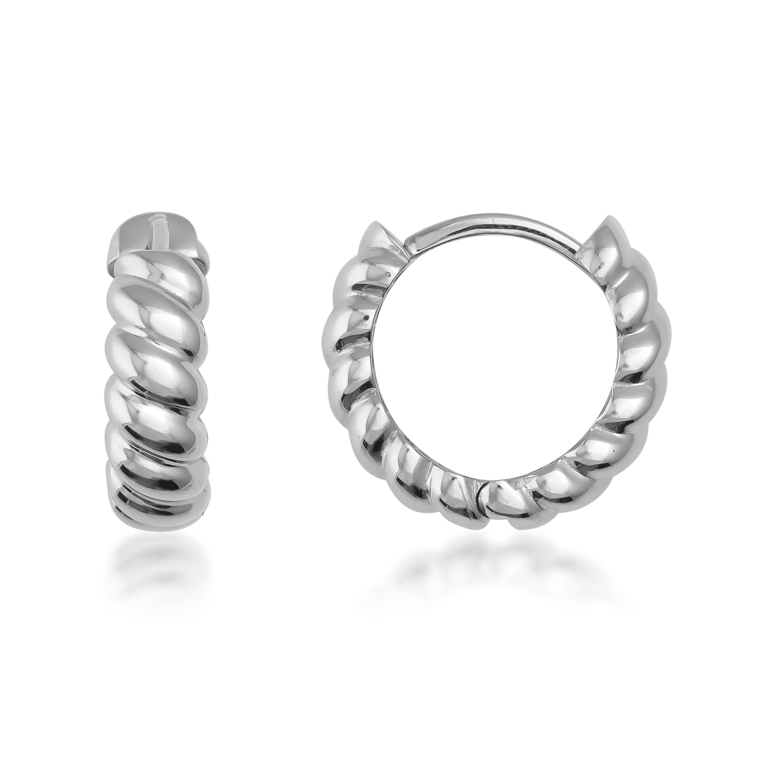 Twisted design silver hoop earrings on white background, modern jewelry style