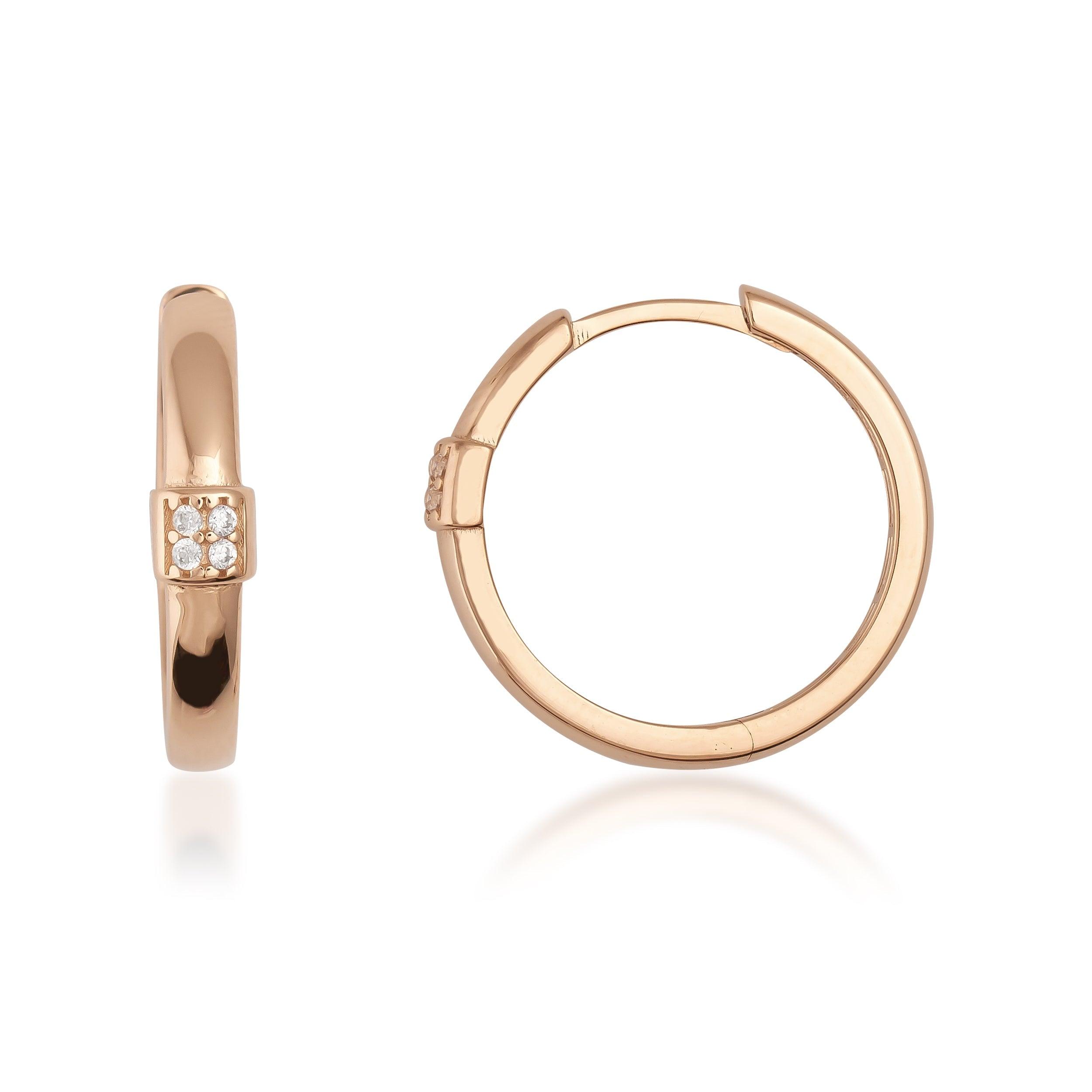 Gold hoop earrings with small diamond accents on white background