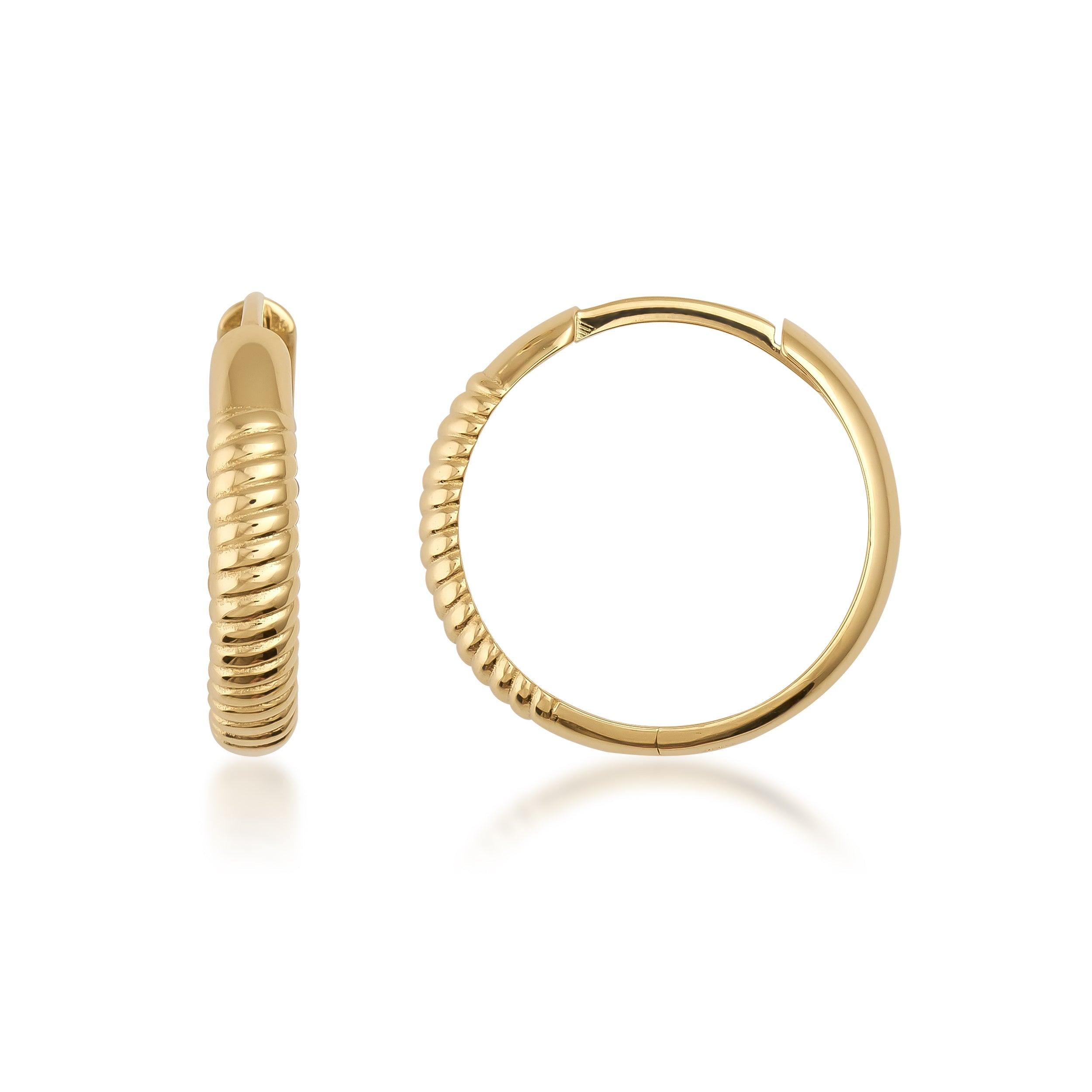 Textured gold hoop earrings with ribbed design on white background