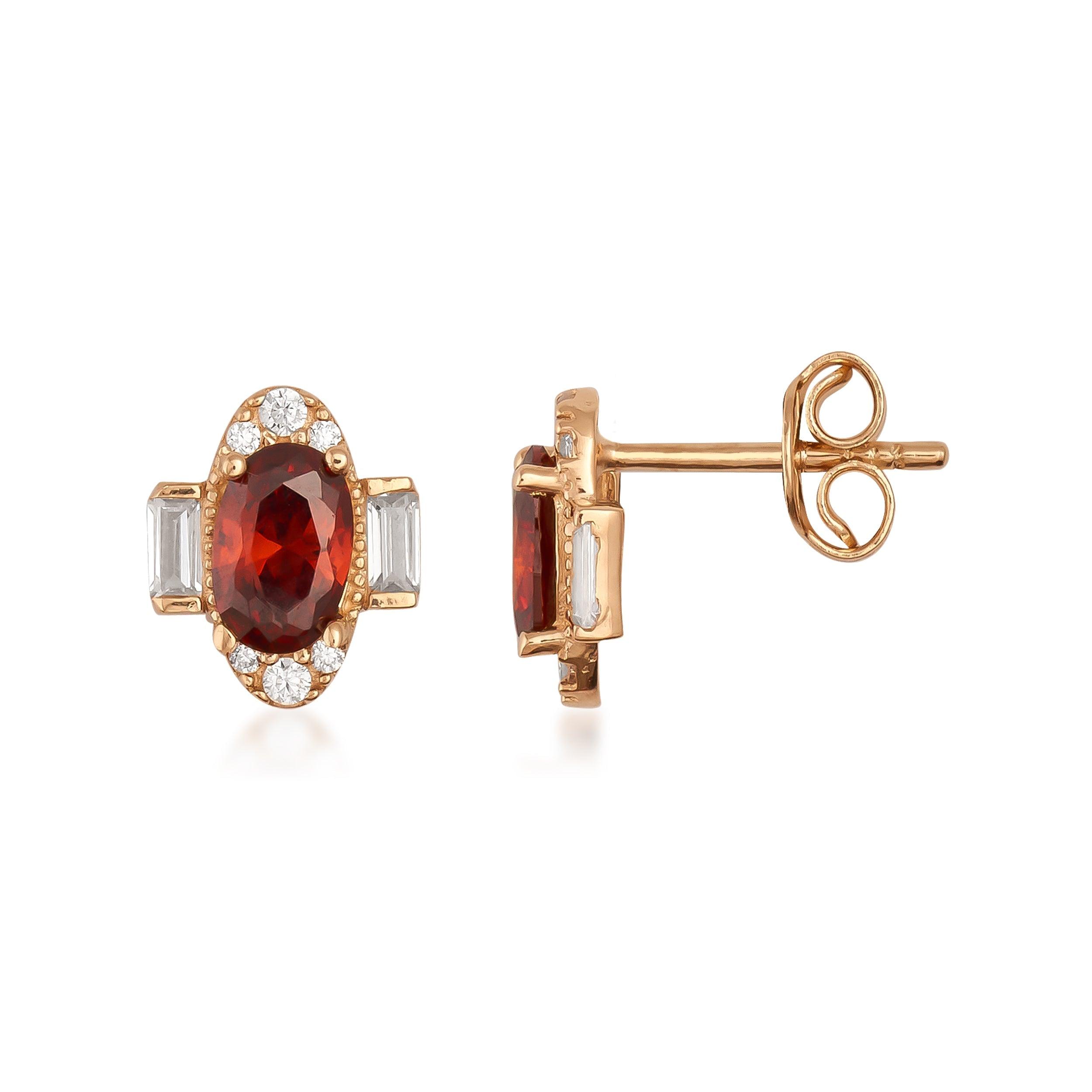 Gold stud earrings with oval red gemstone, baguette accents, and round white stones