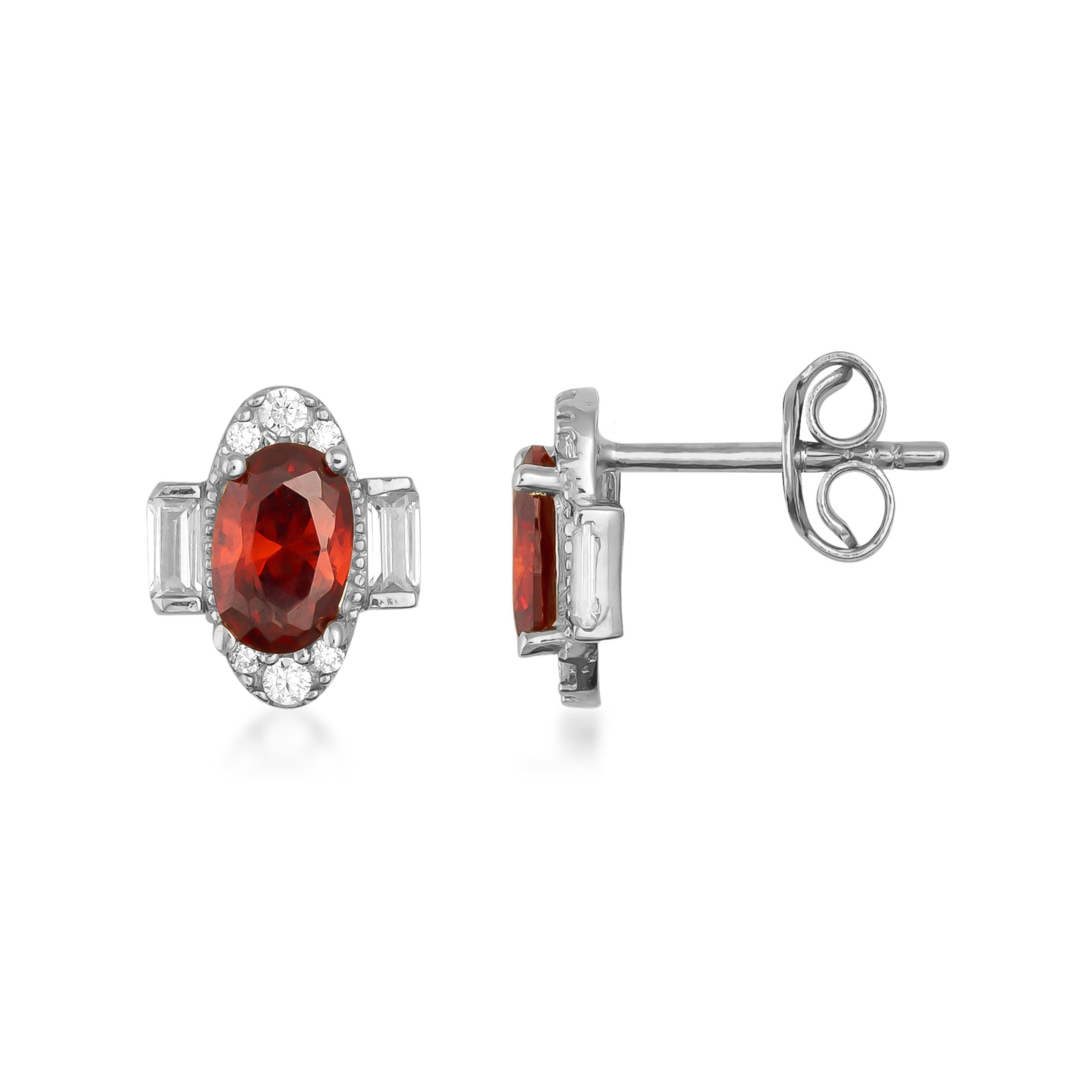 Oval red gemstone stud earrings with diamond accents in white gold setting