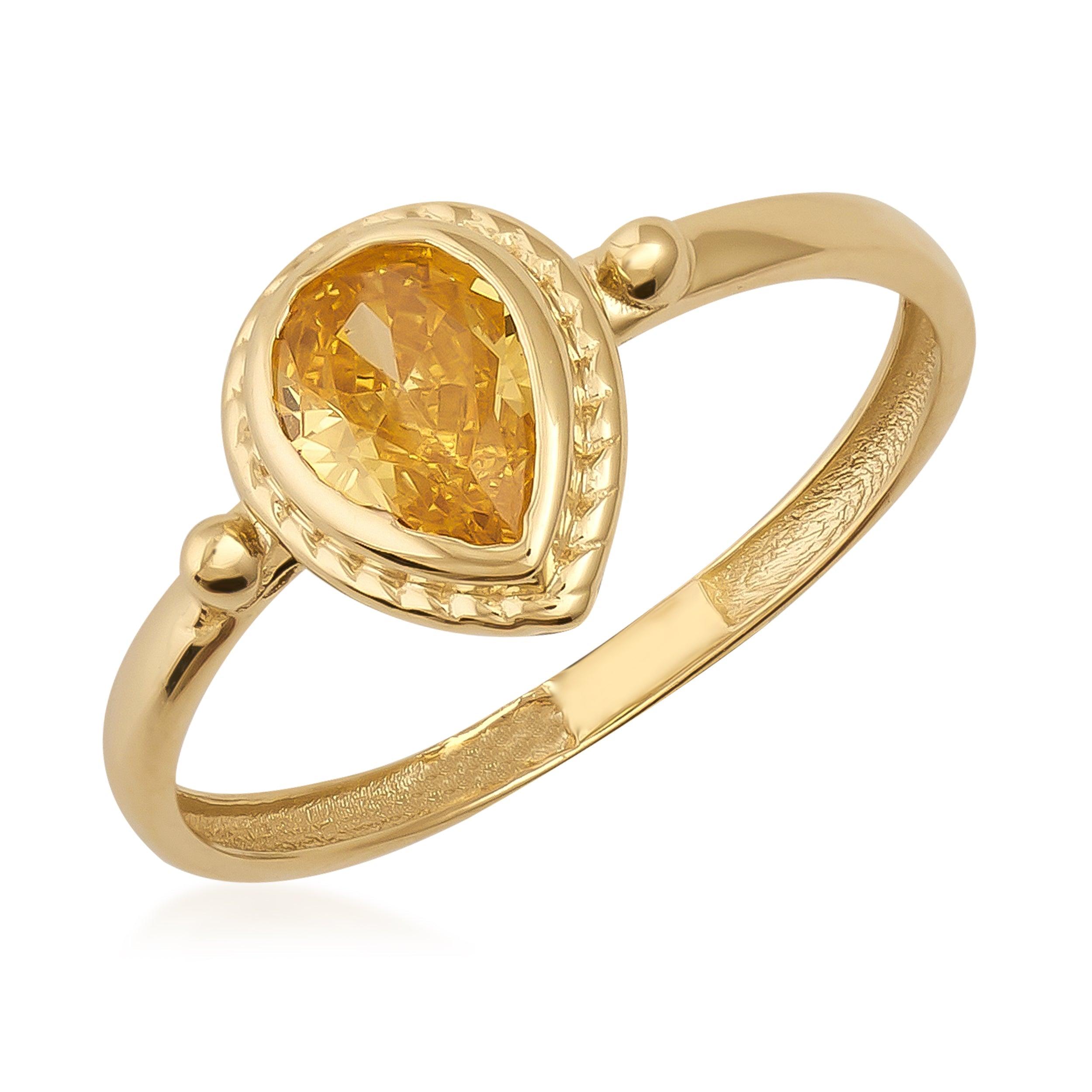 Gold ring with a pear-shaped yellow gemstone and detailed bezel setting