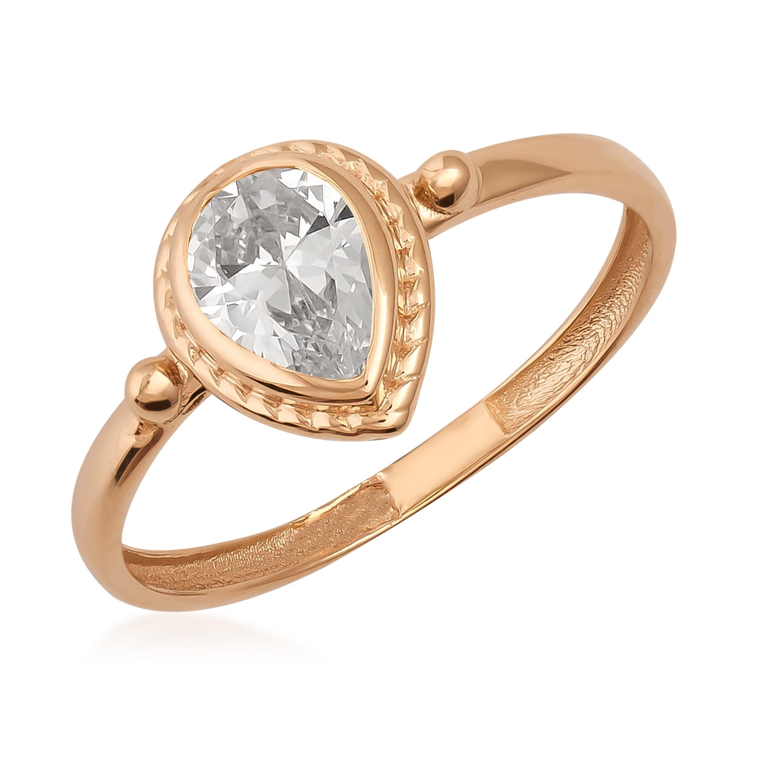 Rose gold ring with pear-shaped clear gemstone and intricate bezel setting