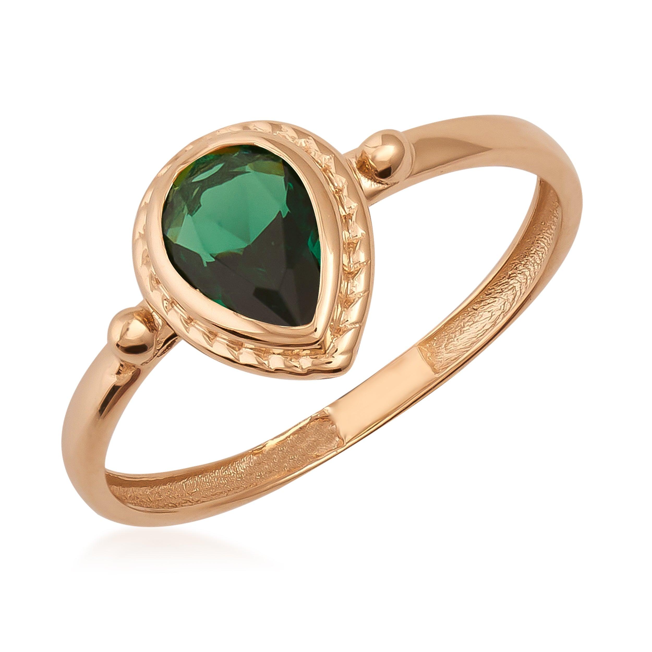 Gold ring with teardrop-shaped green gemstone, elegant jewelry design
