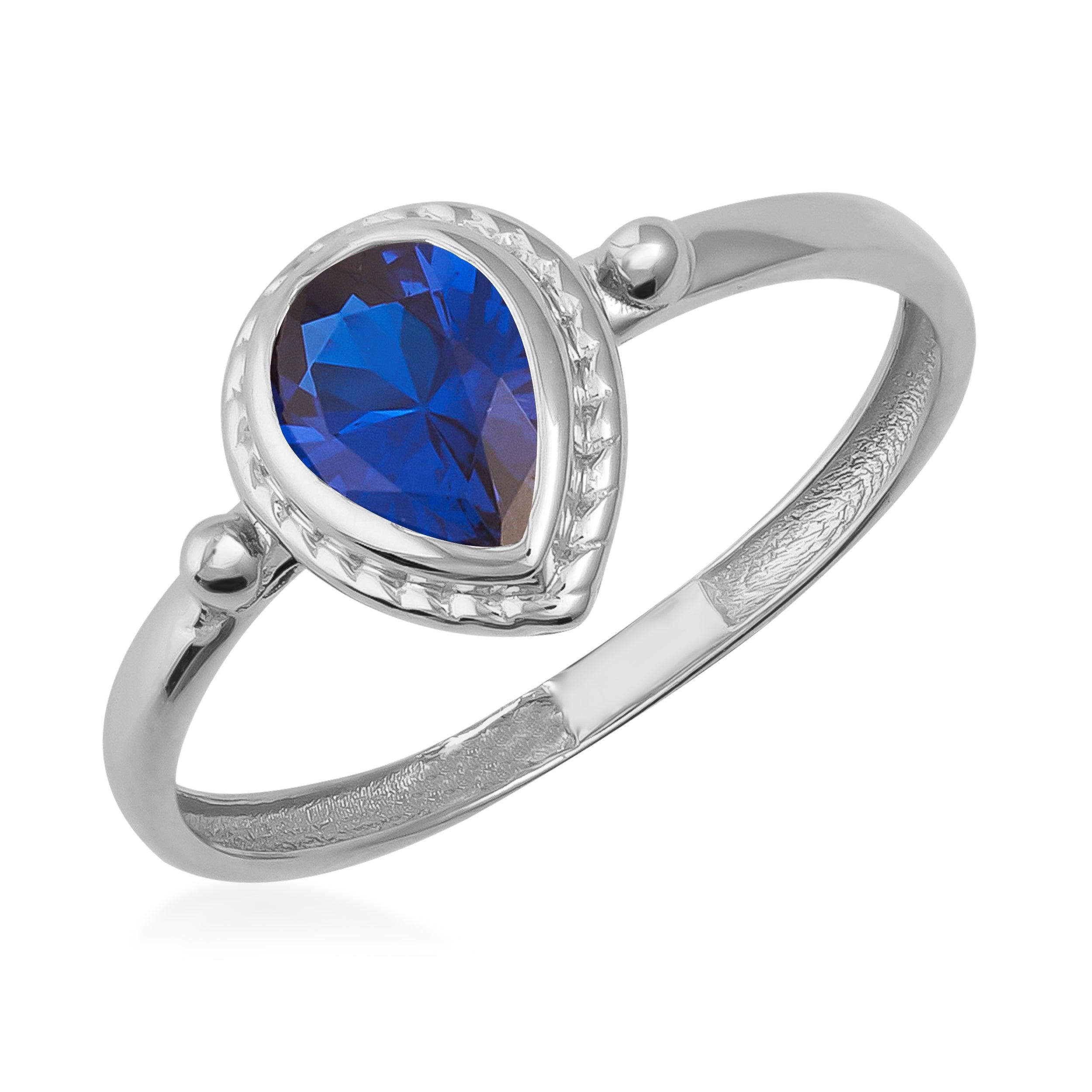 Silver ring with a pear-shaped blue gemstone and textured detailing on the band