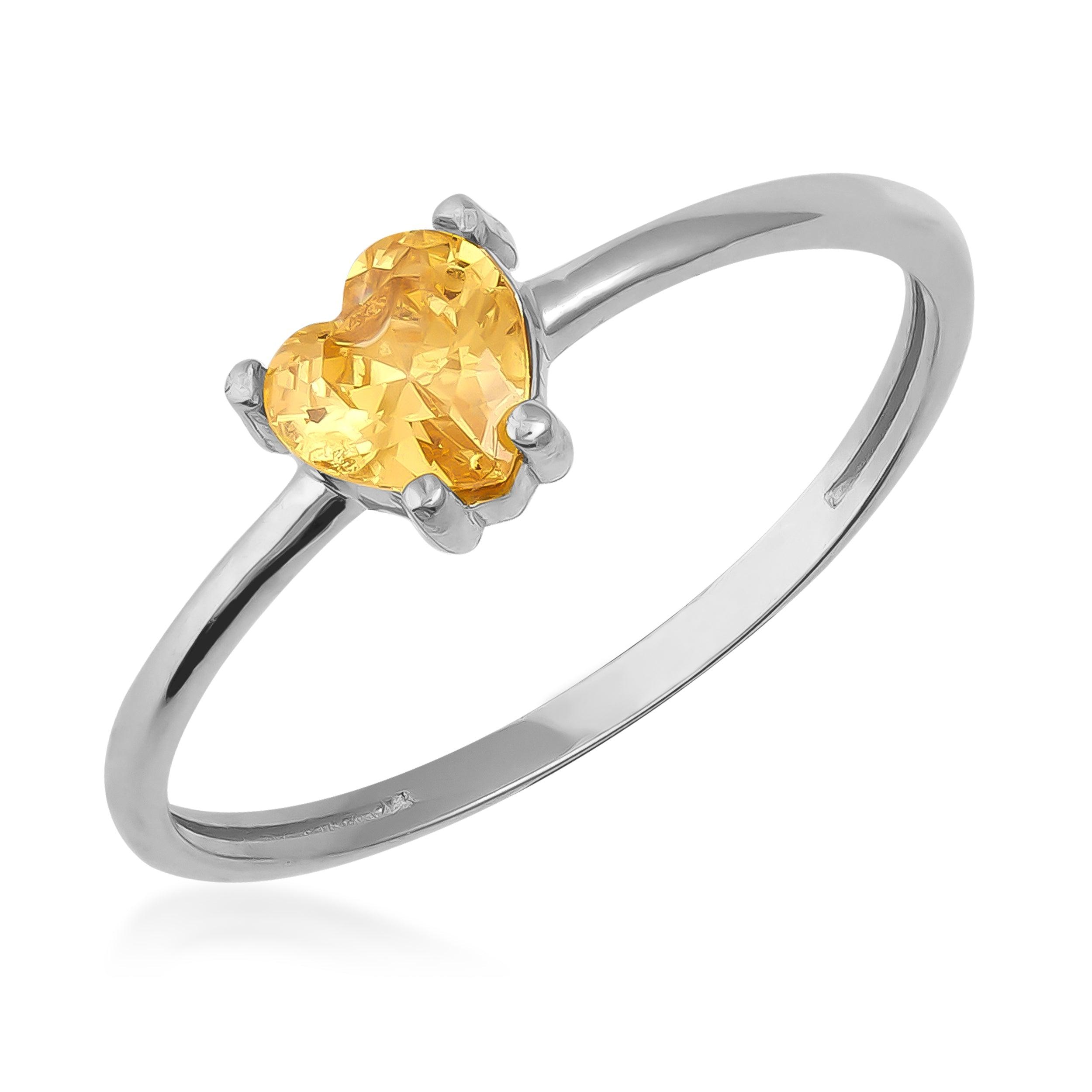 Gold heart-shaped gemstone ring with a polished silver band, elegant jewelry design