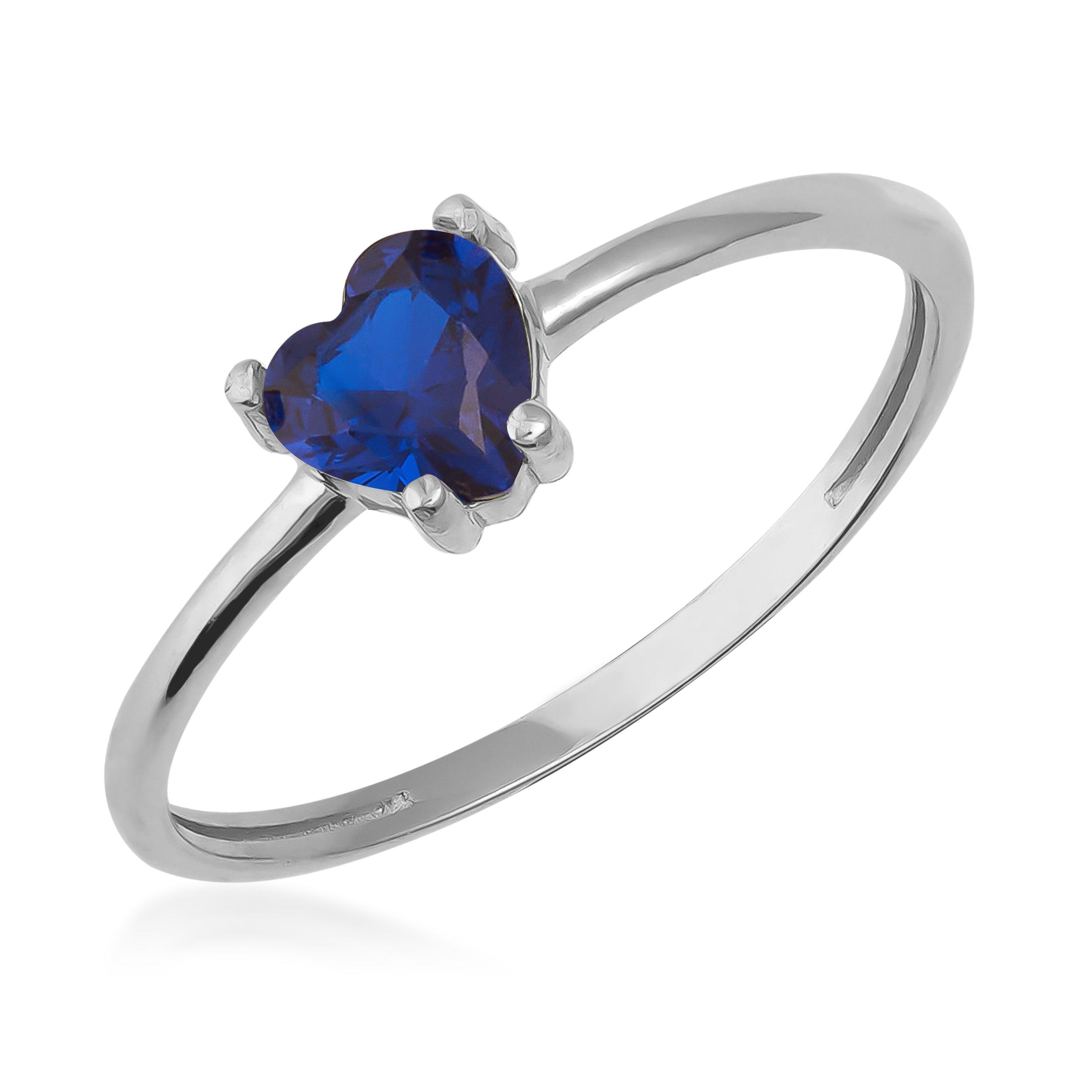 Silver ring with heart-shaped blue gemstone, minimalist jewelry design