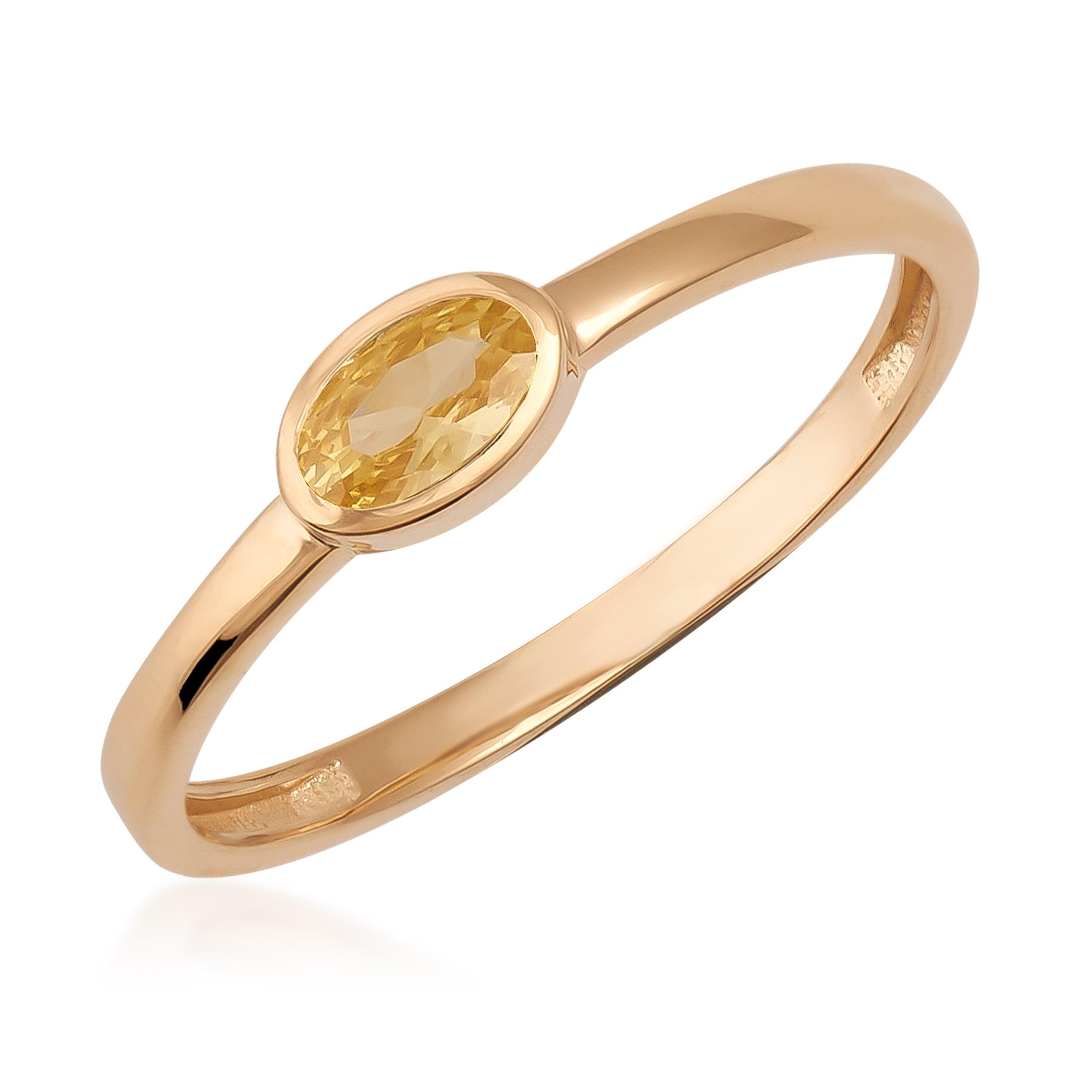 Elegant gold ring with oval yellow gemstone on white background, fine jewelry product photo