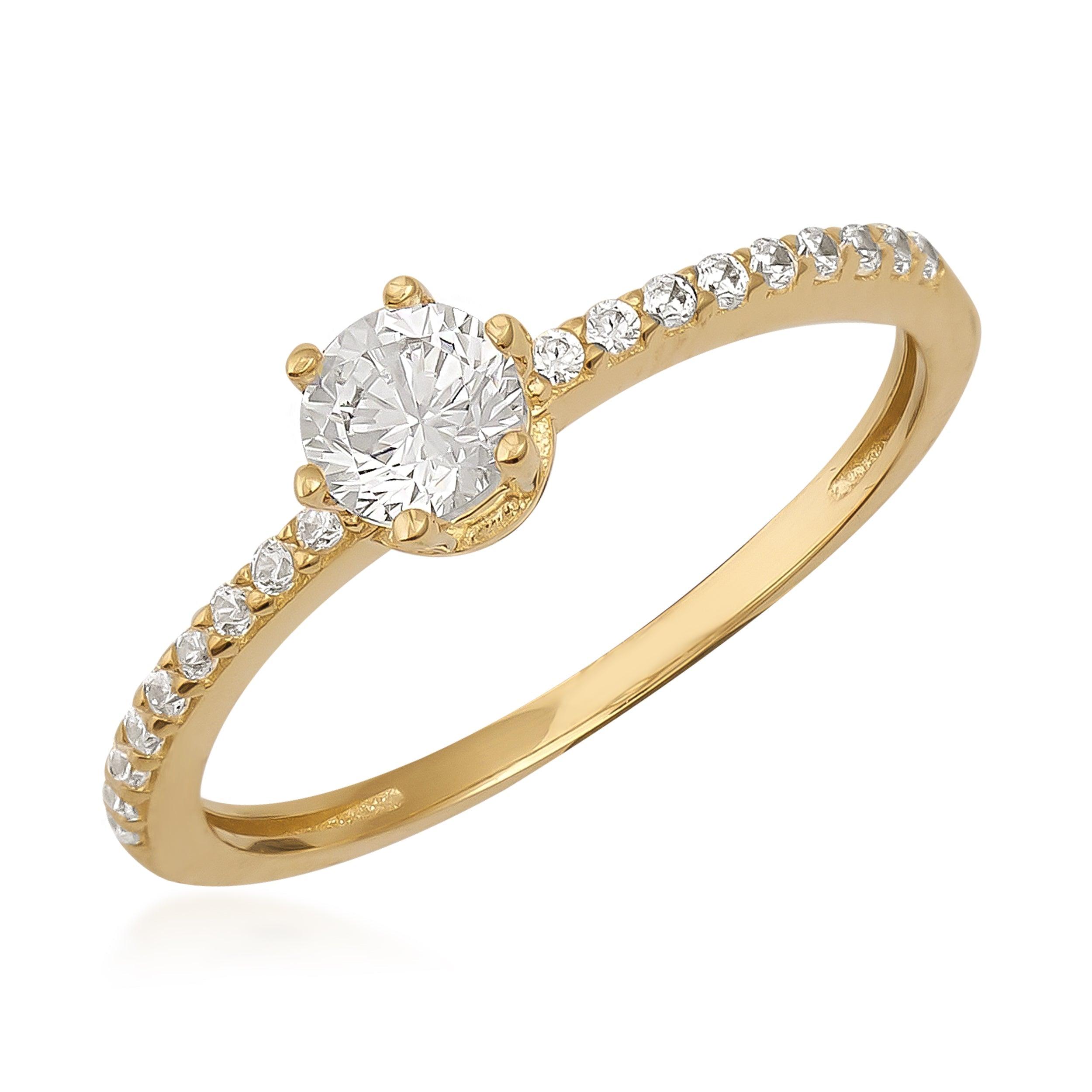 Gold engagement ring with round diamond center and pavé diamond band on white background.