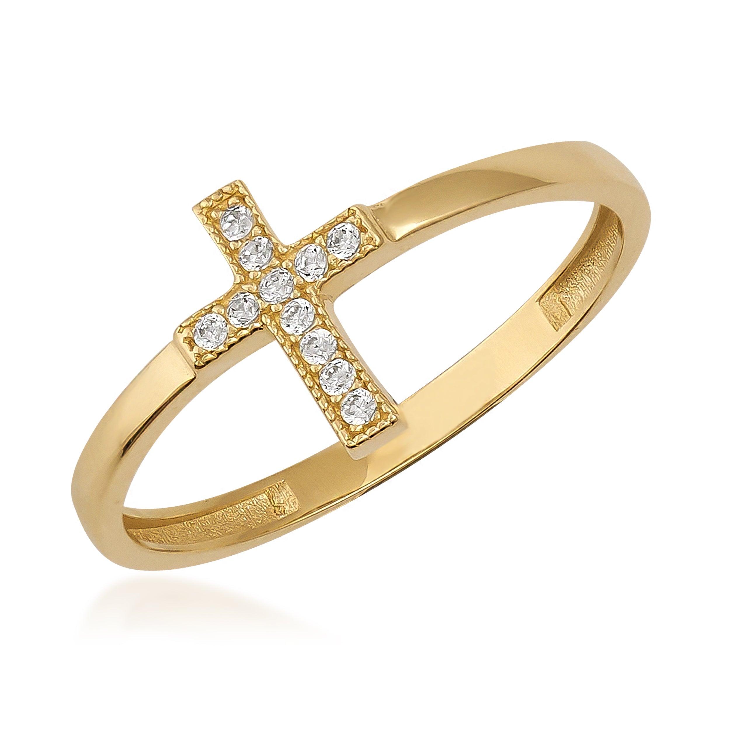 Gold ring with a cross design set with round clear gemstones on white background