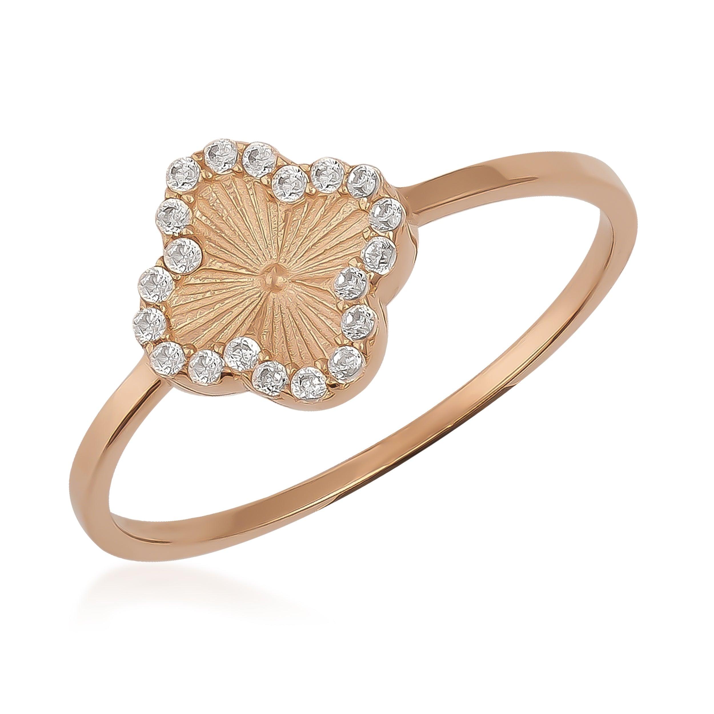Delicate gold ring with textured clover design and diamond accents on a white background