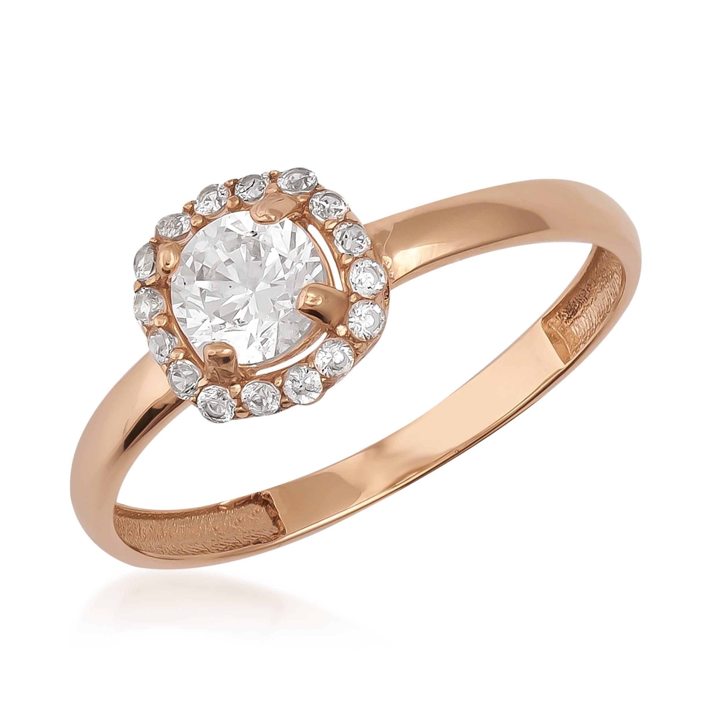 Rose gold ring with round center stone and halo of small clear gemstones
