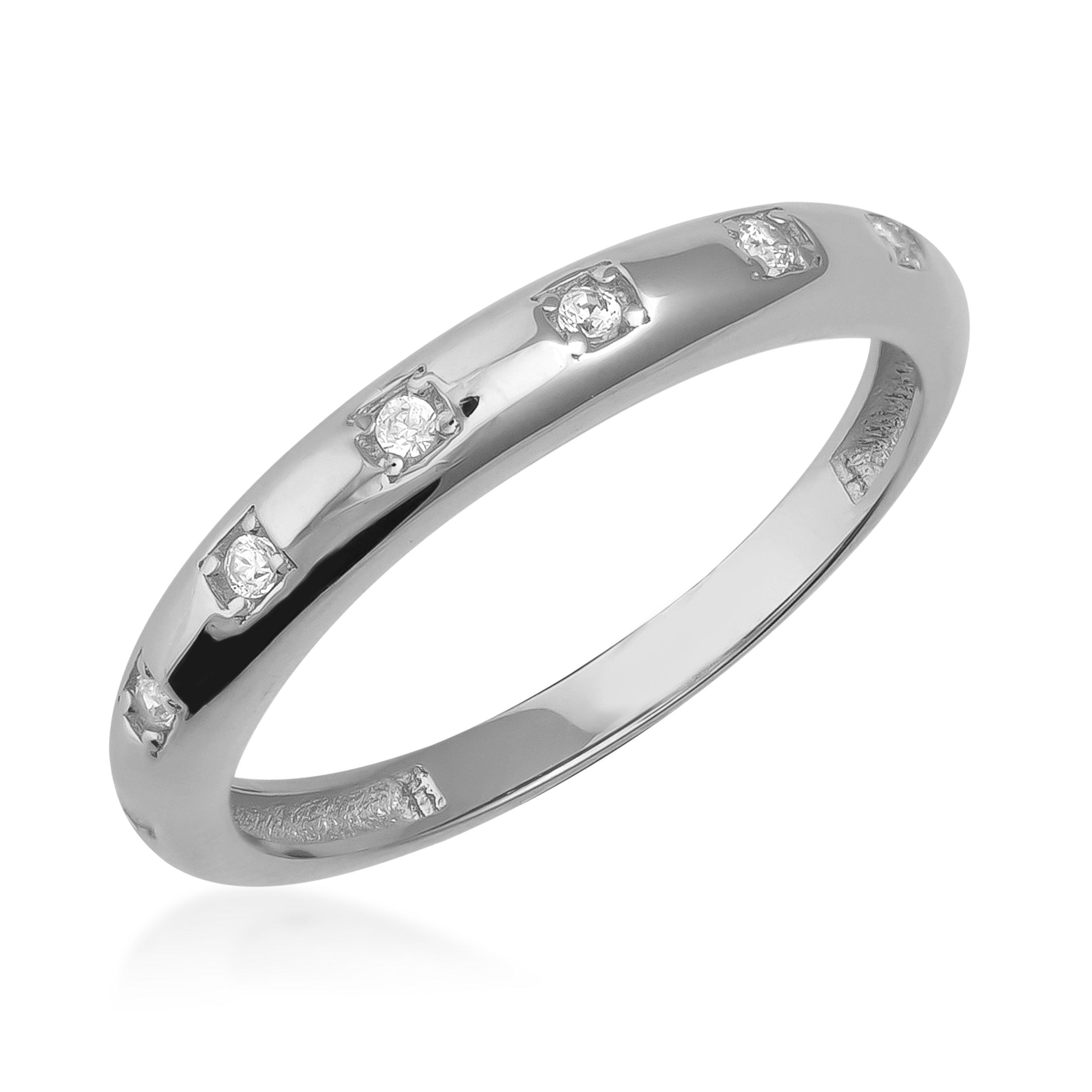 White gold band ring with evenly spaced round diamonds on a white background