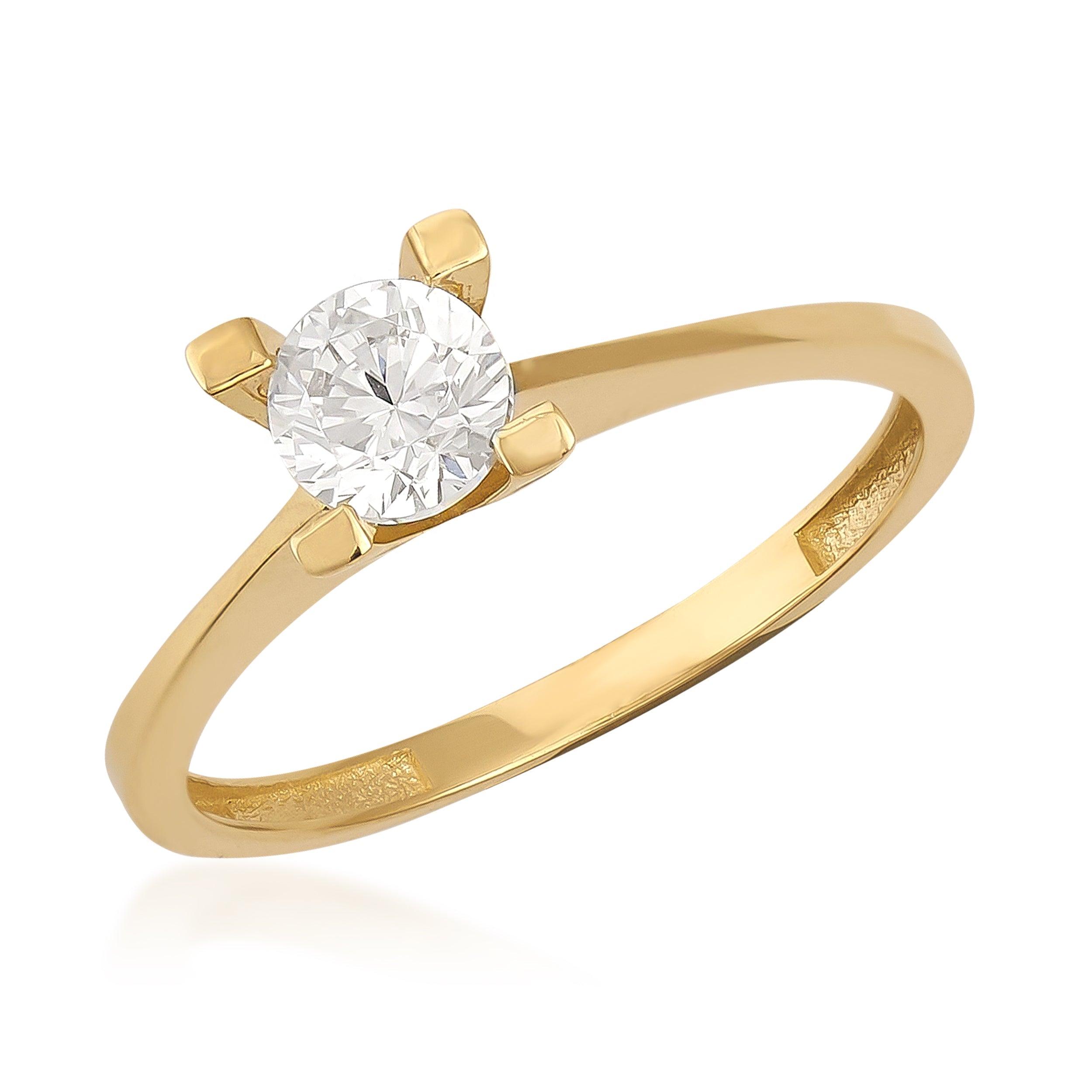 Gold solitaire ring with round brilliant cut diamond set in four prong setting