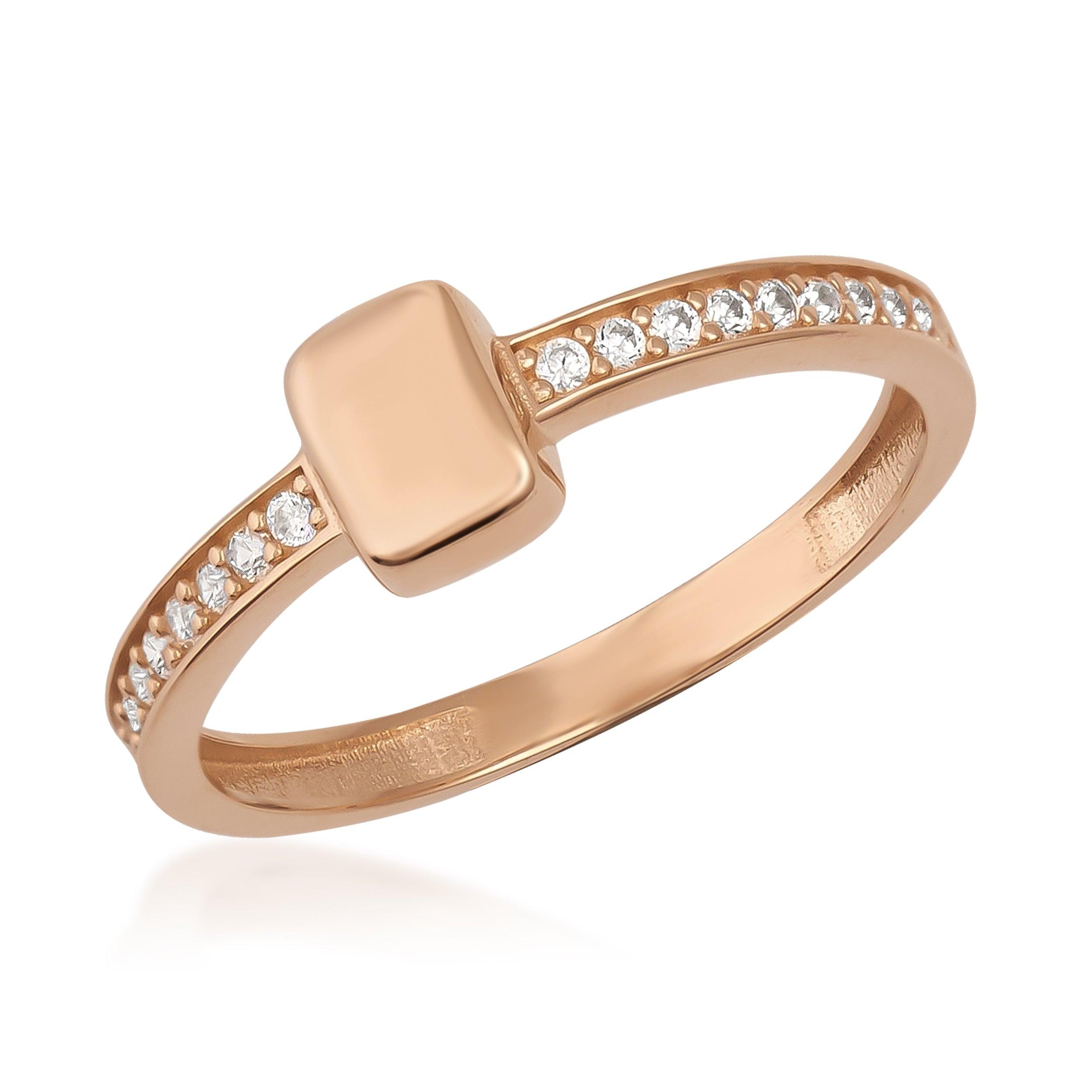 Rose gold ring with a rectangular center and small clear gemstones along the band