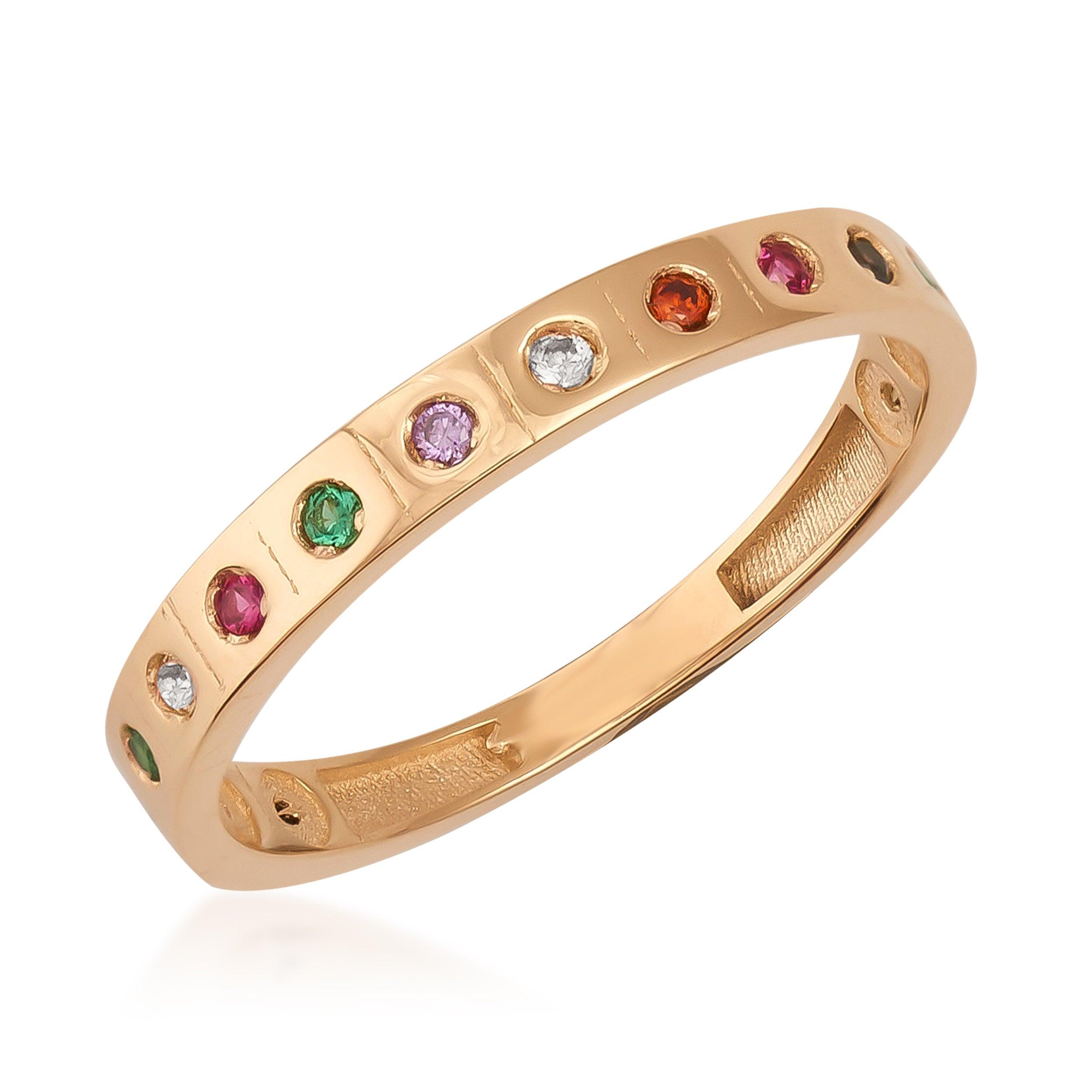 Gold band ring with multicolored gemstones set in a minimalist, elegant design