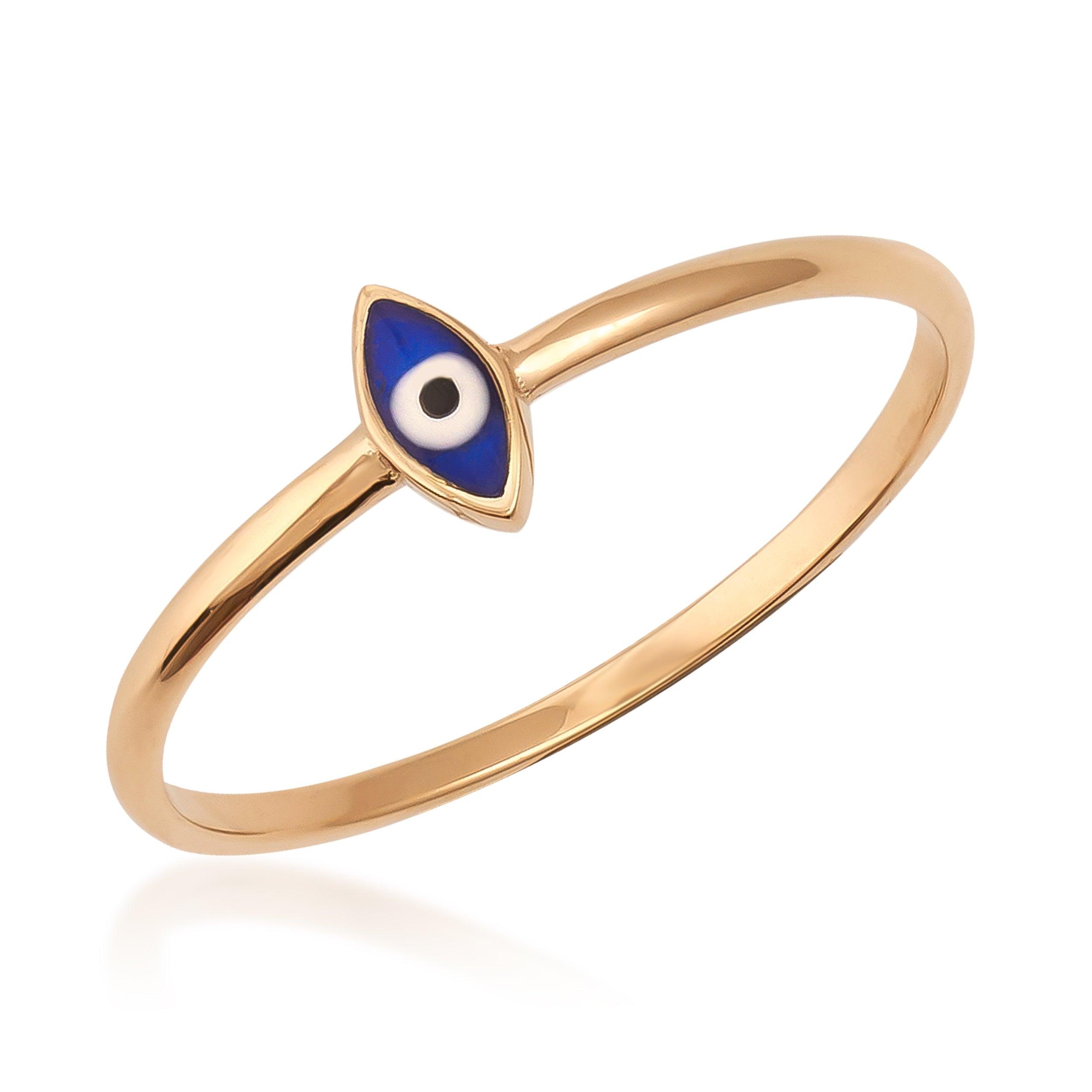 Gold ring with blue evil eye enamel charm on white background