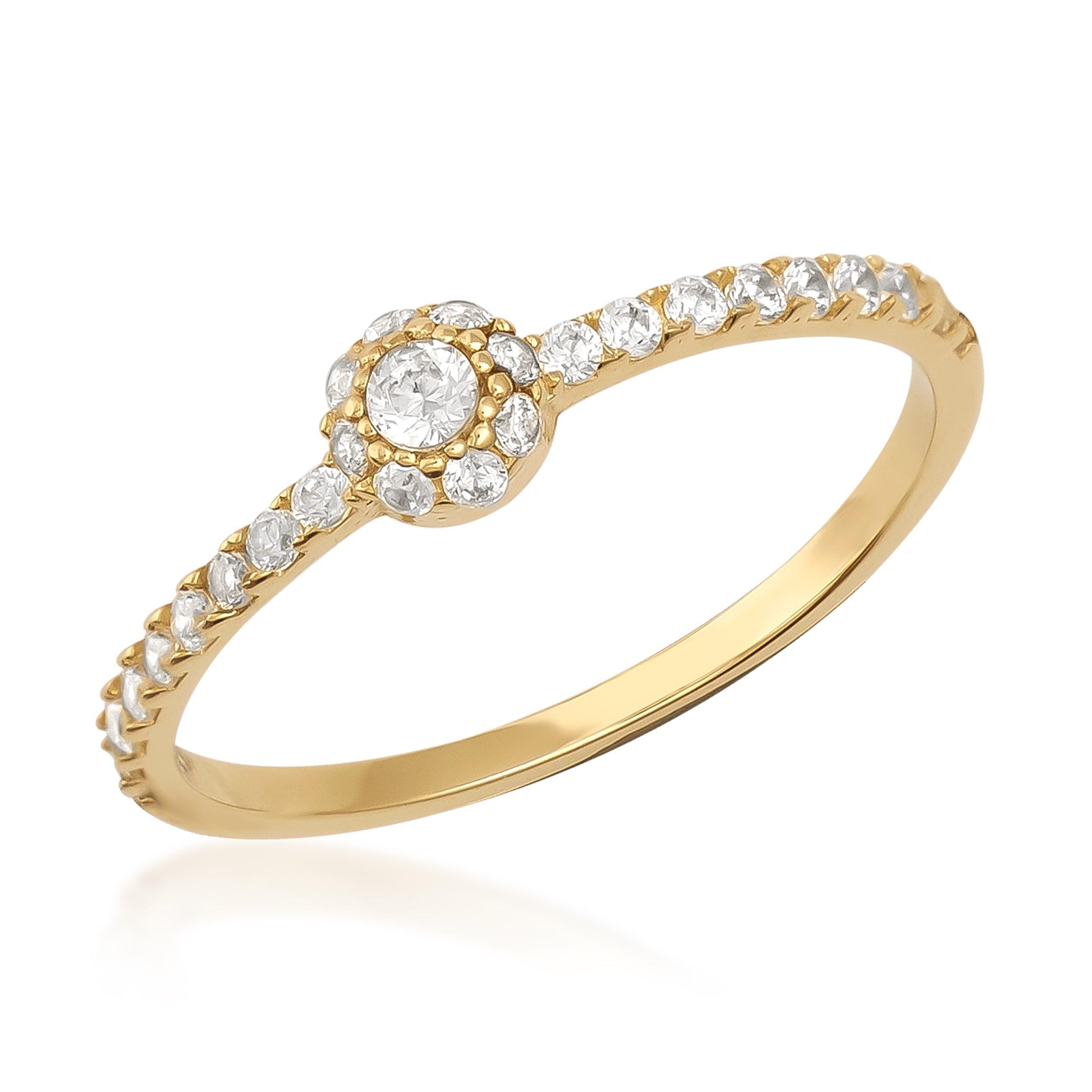 Delicate gold ring with round center diamond and pavé diamond band on white background