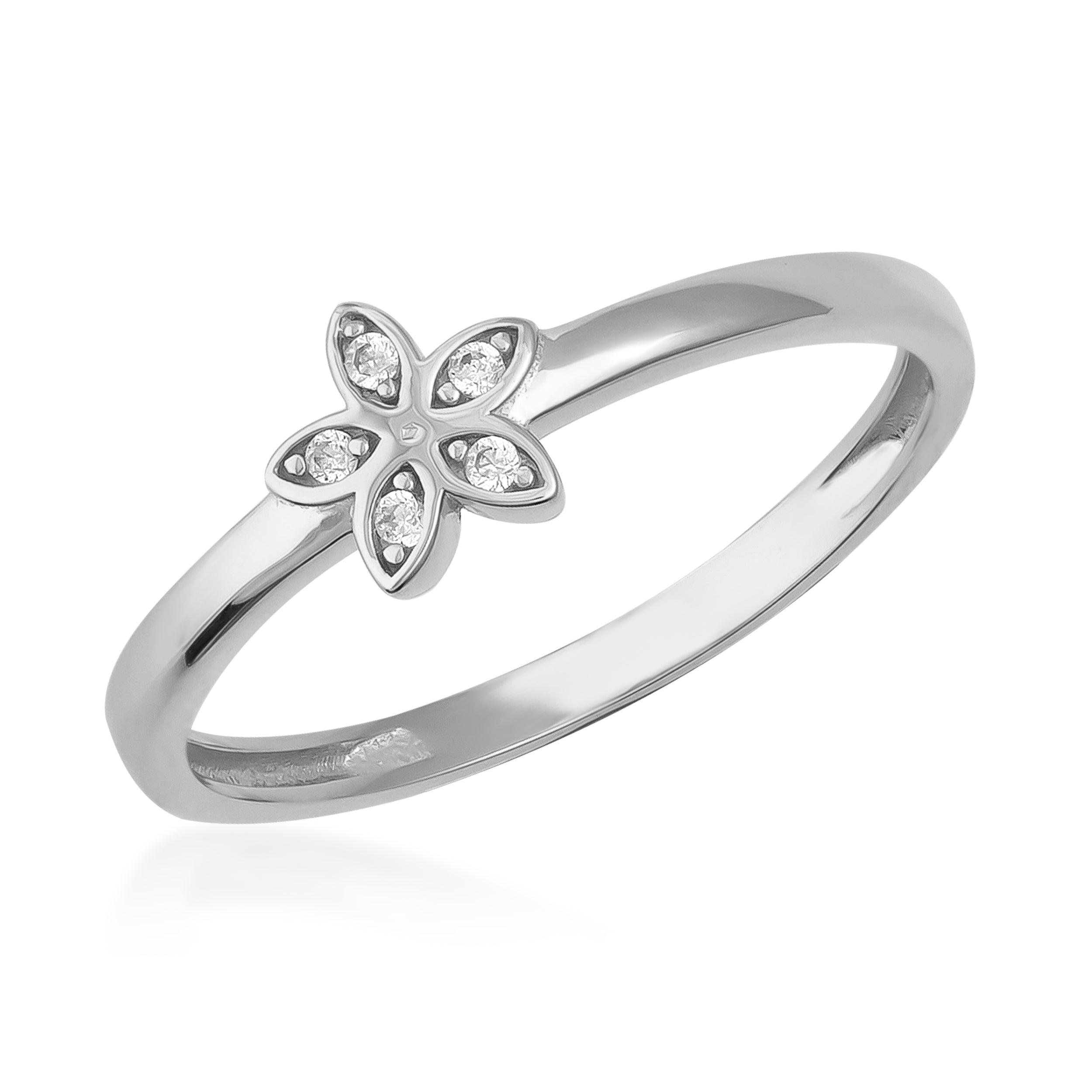 White gold ring with flower-shaped diamond cluster on a polished band