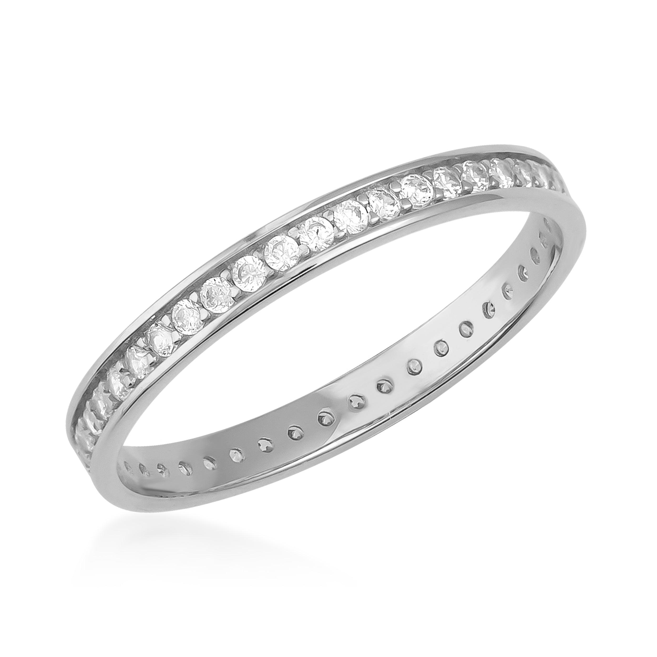 white gold eternity band with round cut diamonds in a channel setting on white background