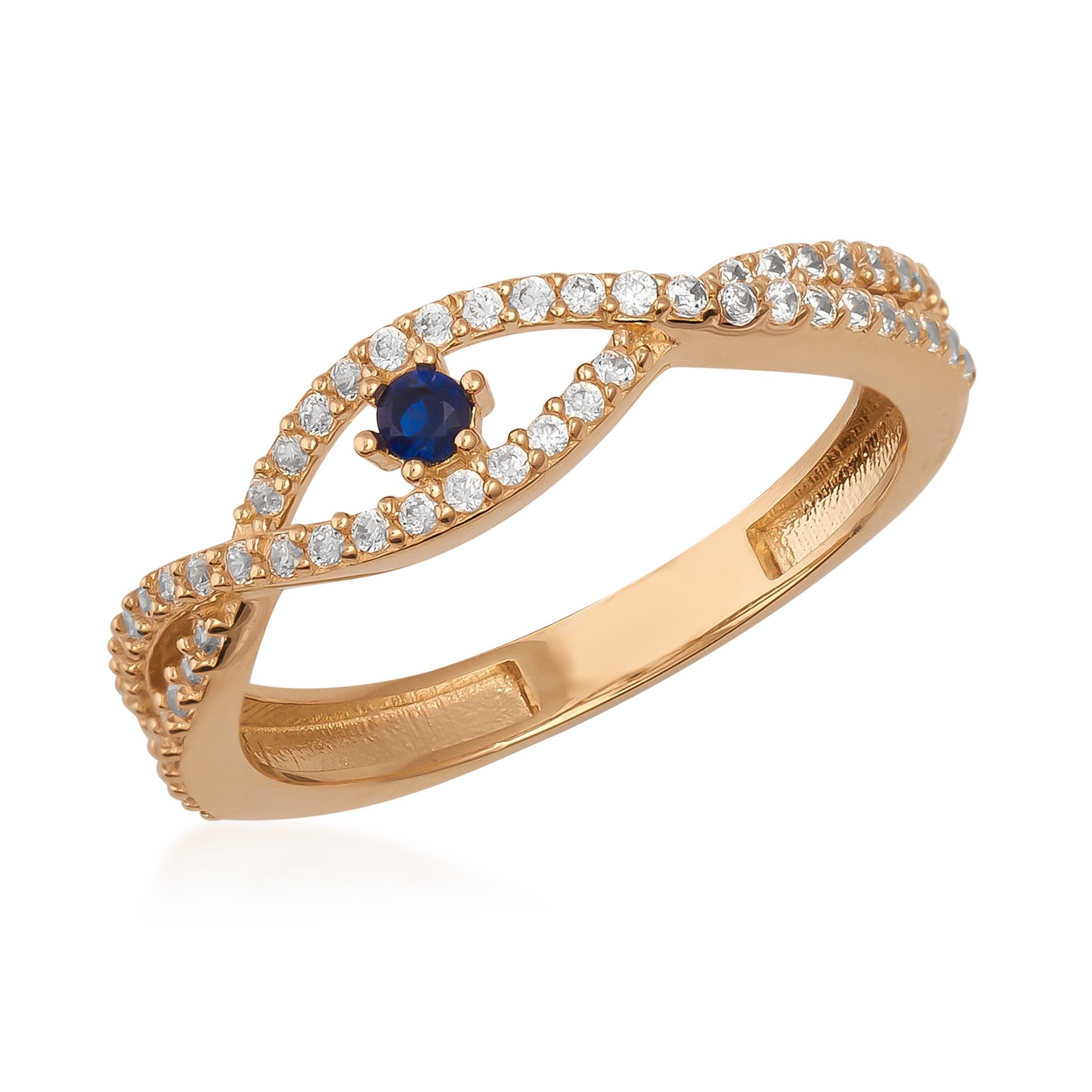 Gold ring with a twisted band, white gemstones, and a central blue gemstone accent