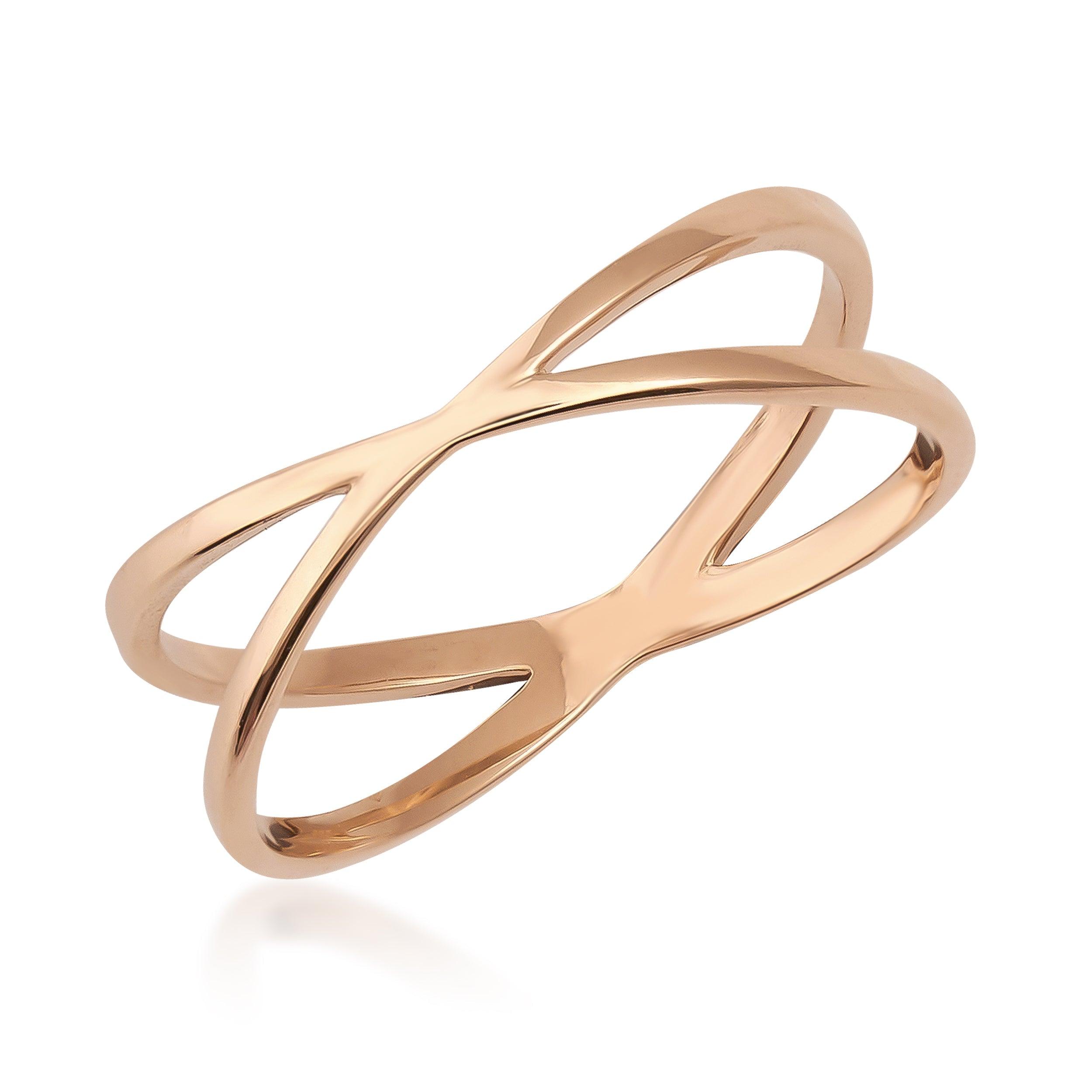 Minimalist gold crossover ring with a polished finish on white background