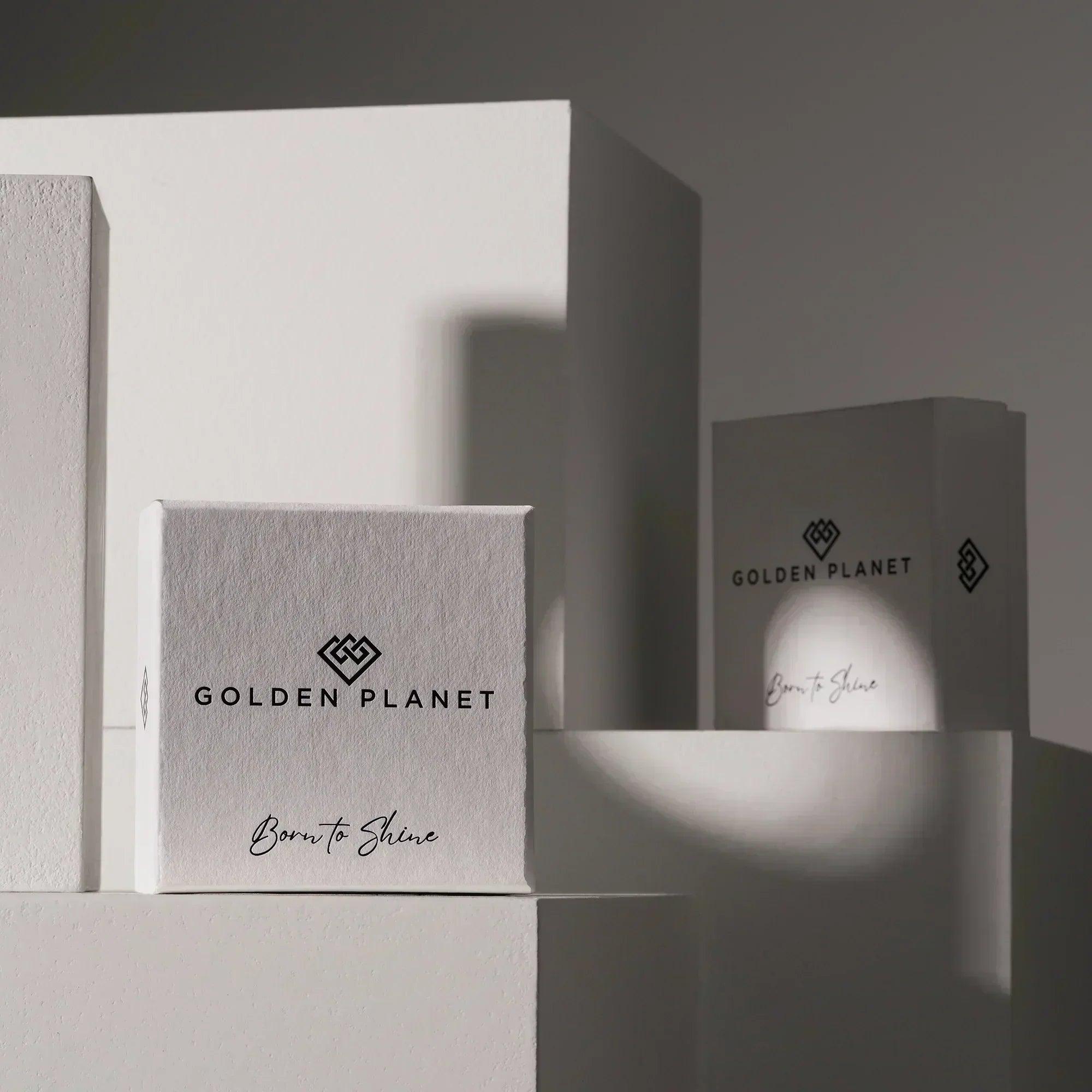 Elegant white jewelry boxes with modern logo, minimal design, and soft shadows